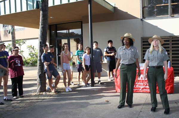 U.S. Army Corps of Engineers' Park Rangers Angela Jones (left center) and Samantha Vazquez welcome more than 50 volunteers from the U.S. Army Corps of Engineers, local JROTC students and others, to the Corps' Earth Day 2016 clean up of the Fort DeRussy beach and berm area as part of Earth Month 2016.  
