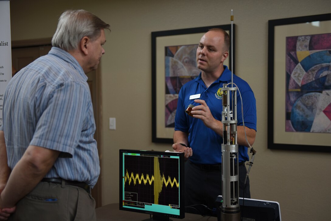 U.S. Air Force Staff Sgt. Cori B. Gawthrop, 312th Training Squadron instructor, shows an Angelo State University Academic Fair attendee a seismometer at ASU in San Angelo, Texas, April 9, 2016. The Air Force uses seismometers to determine the difference between earthquakes and nuclear blasts. (U.S. Air Force photo by Airman Chase Sousa/Released)