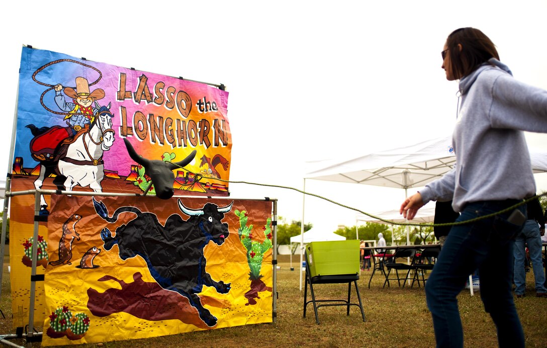 A participant plays Lasso the Longhorn during the "Kids First" Fair event at the Goodfellow Air Force Base Landings in San Angelo, Texas, April 9, 2016. The fair hosted numerous games for children to play including a military working dog training demonstration. (U.S. Air Force photo by Senior Airman Scott Jackson/released)