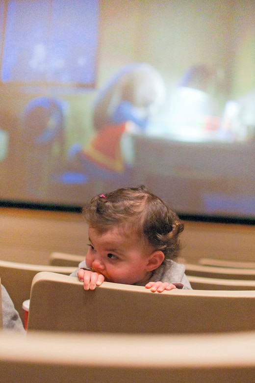 A one-year-old military child attends the first sensory-friendly movie on April 9 at 2:30 pm. The Exceptional Family Member Program coordinated with the theater staff to show Disney’s animated film “Zootopia” for the matinee featured film. John Smith, Little Hall Theater manager, counted more than 250 guests during the Saturday matinee.