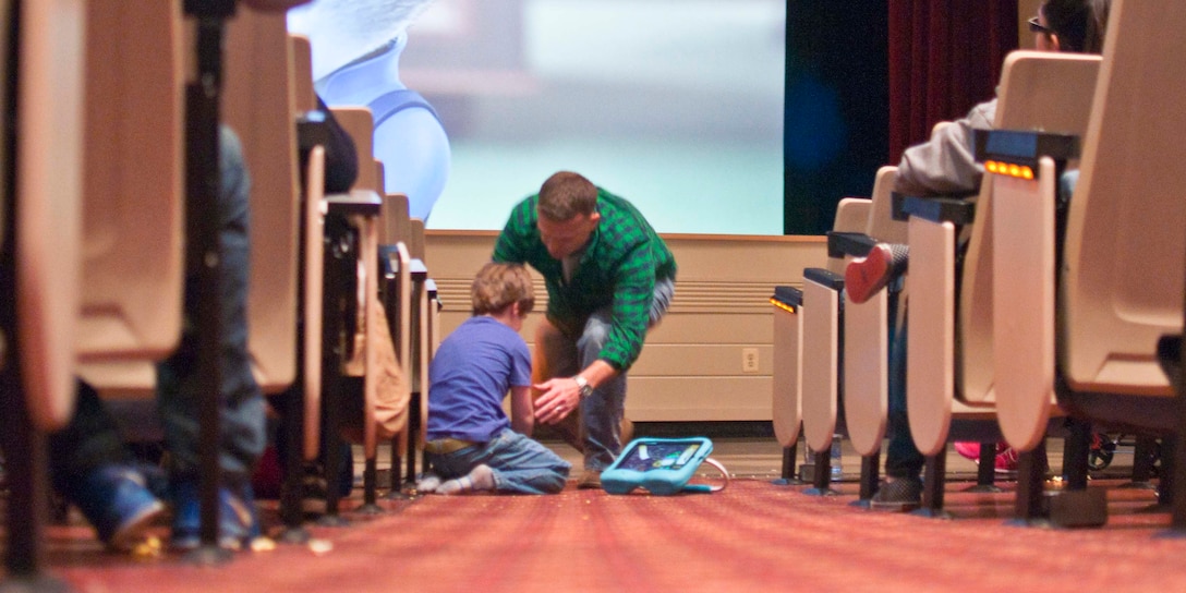 Lt. Col. Kevin Digman, Marine Corps University student, and his six-year-old son attend the showing of Disney’s animated film “Zootopia” during the first sensory-friendly movie at Little Hall on April 9.