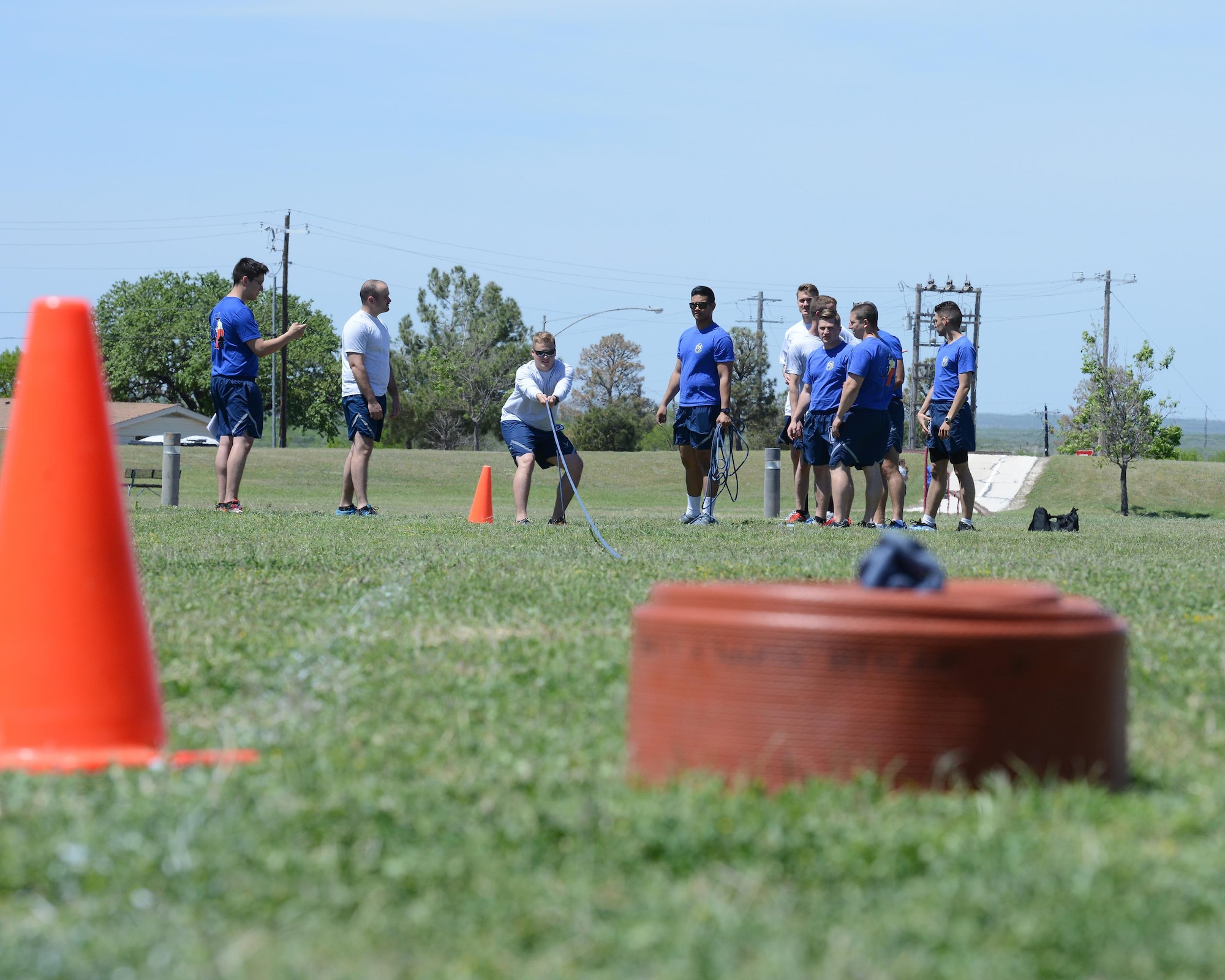 2nd Lt. Erik Mccullough, 47th Student Squadron awaiting pilot training, prepares to pull a firehose at Laughlin Air Force Base, Texas, April 5, 2016. For the firehose pull, competitors must pull a 45-pound hose 50 yards while sprinting. (U.S. Air Force photo by Senior Airman Jimmie D. Pike)