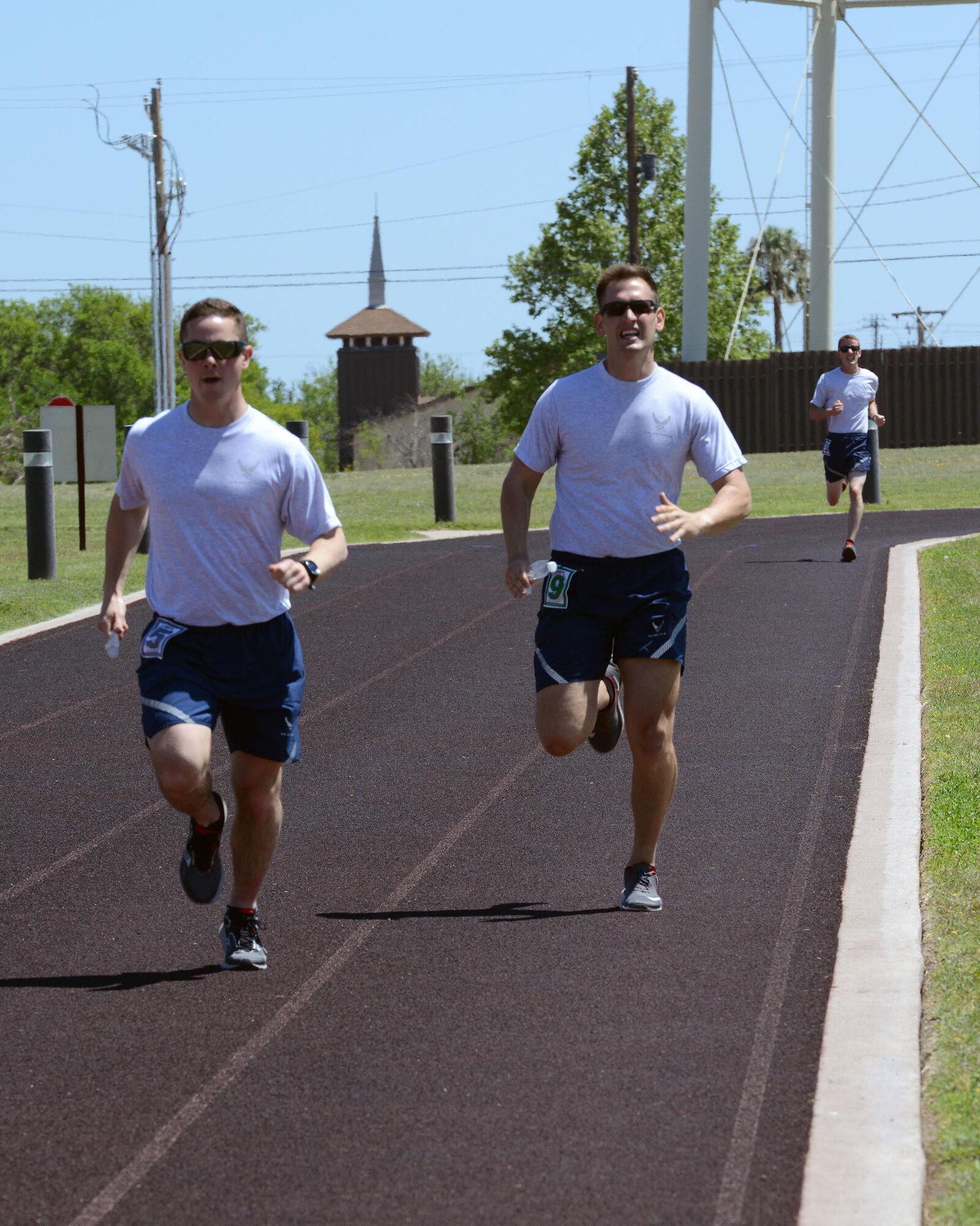 2nd Lt. Daniel Corriero, 47th Student Squadron awaiting pilot training, left, and 2nd Lt. Austin Foster, 47th STUS awaiting pilot training, right, run on the track at Laughlin Air Force Base, Texas, April 5, 2016. During the Warrior Games, multiple relays were held to help improve cardio and endurance. (U.S. Air Force photo by Senior Airman Jimmie D. Pike)