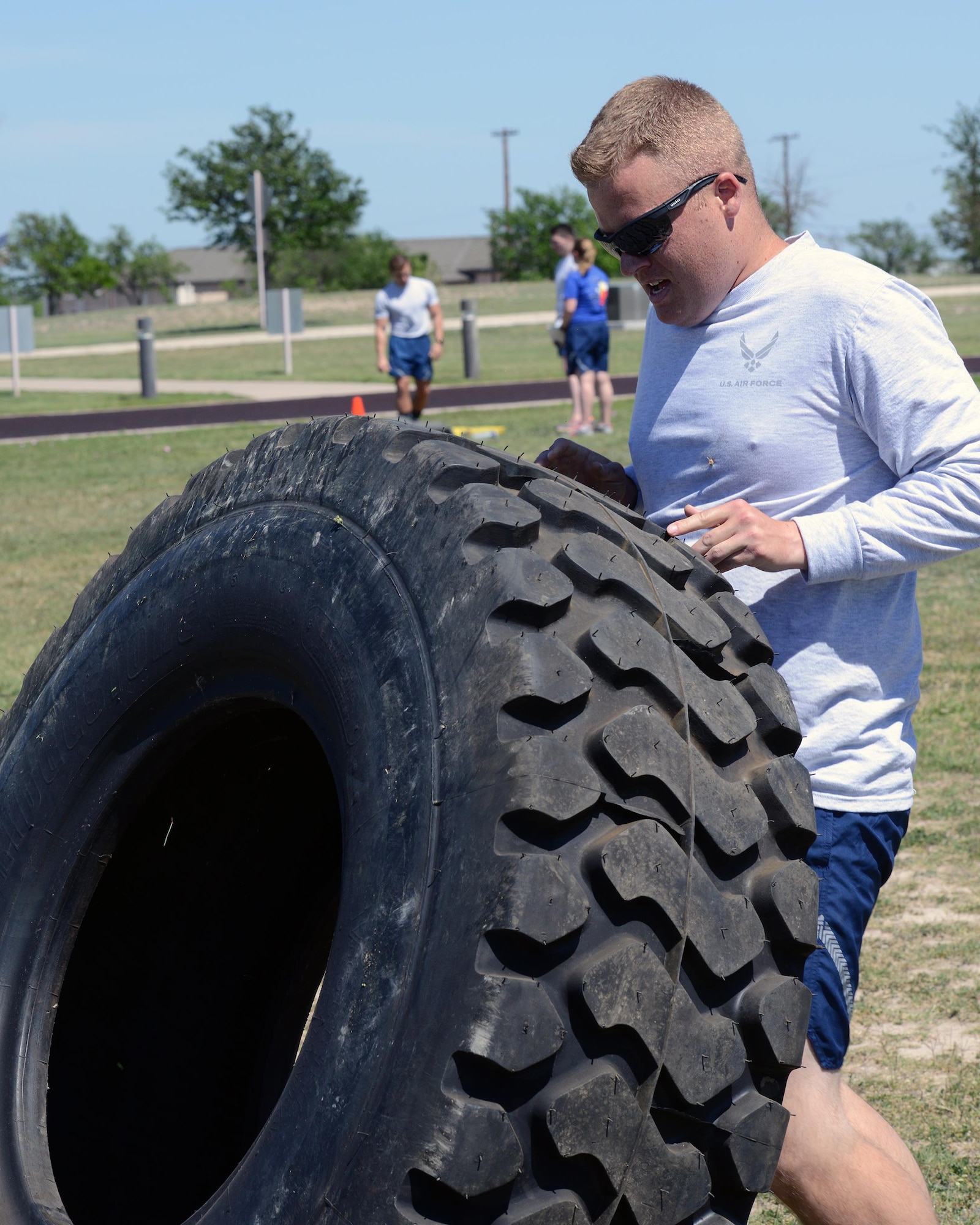 2nd Lt. Erik Mccullough, 47th Student Squadron awaiting pilot training, flips a 310-pound tire at Laughlin Air Force Base, Texas, April 5, 2016. The tire flip was the last event for the Warrior Games and tested the strength, endurance and team work of competitors. (U.S. Air Force photo by Senior Airman Jimmie D. Pike)