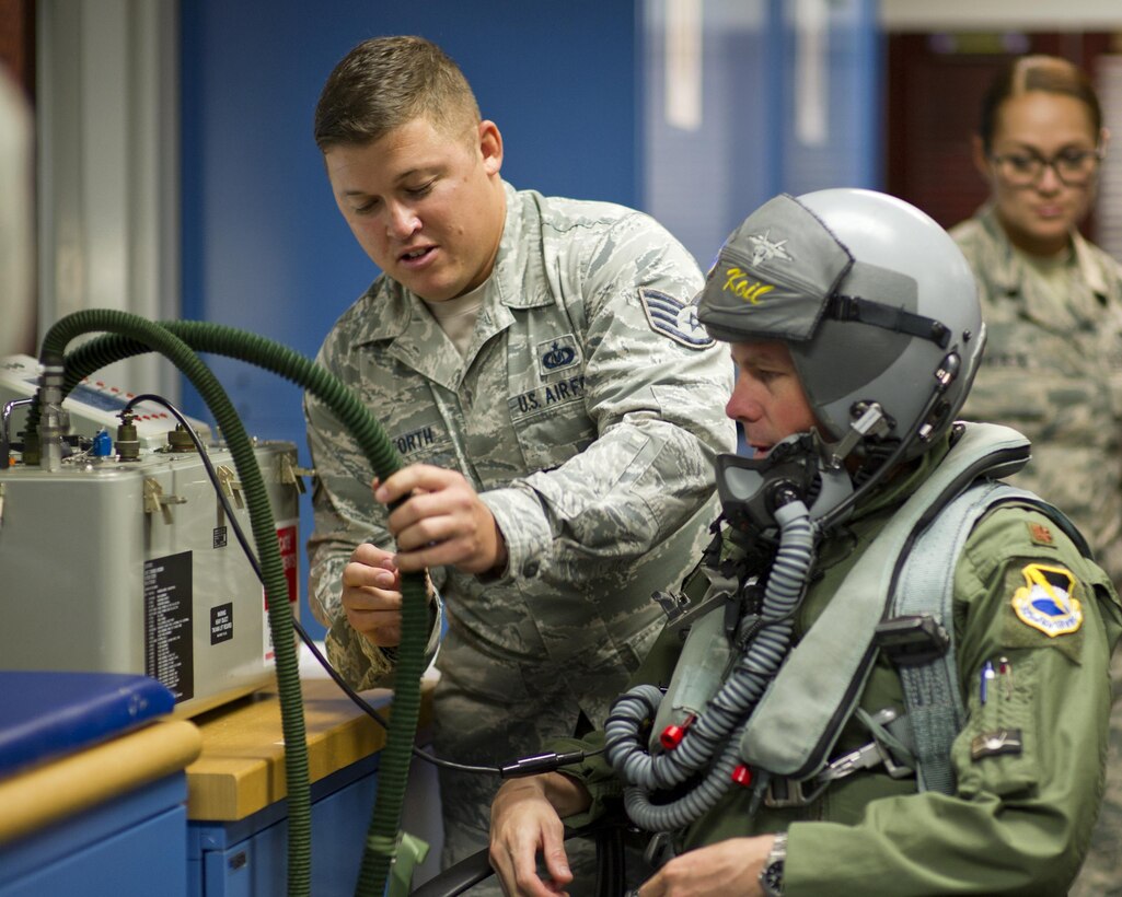 Staff Sgt. Michael Stanforth, 325th Operations Support Squadron/43rd Fighter Squadron Aircrew Flight Equipment floor chief, assists Maj. Adam Keith, 43rd FS Deputy Operations officer, in testing his flight equipment for leaks April 7, at the 43rd FS. Stanforth was selected as this week’s Unsung Hero by his leadership. (U.S. Air Force photo by Senior Airman Alex Fox Echols III/Released)