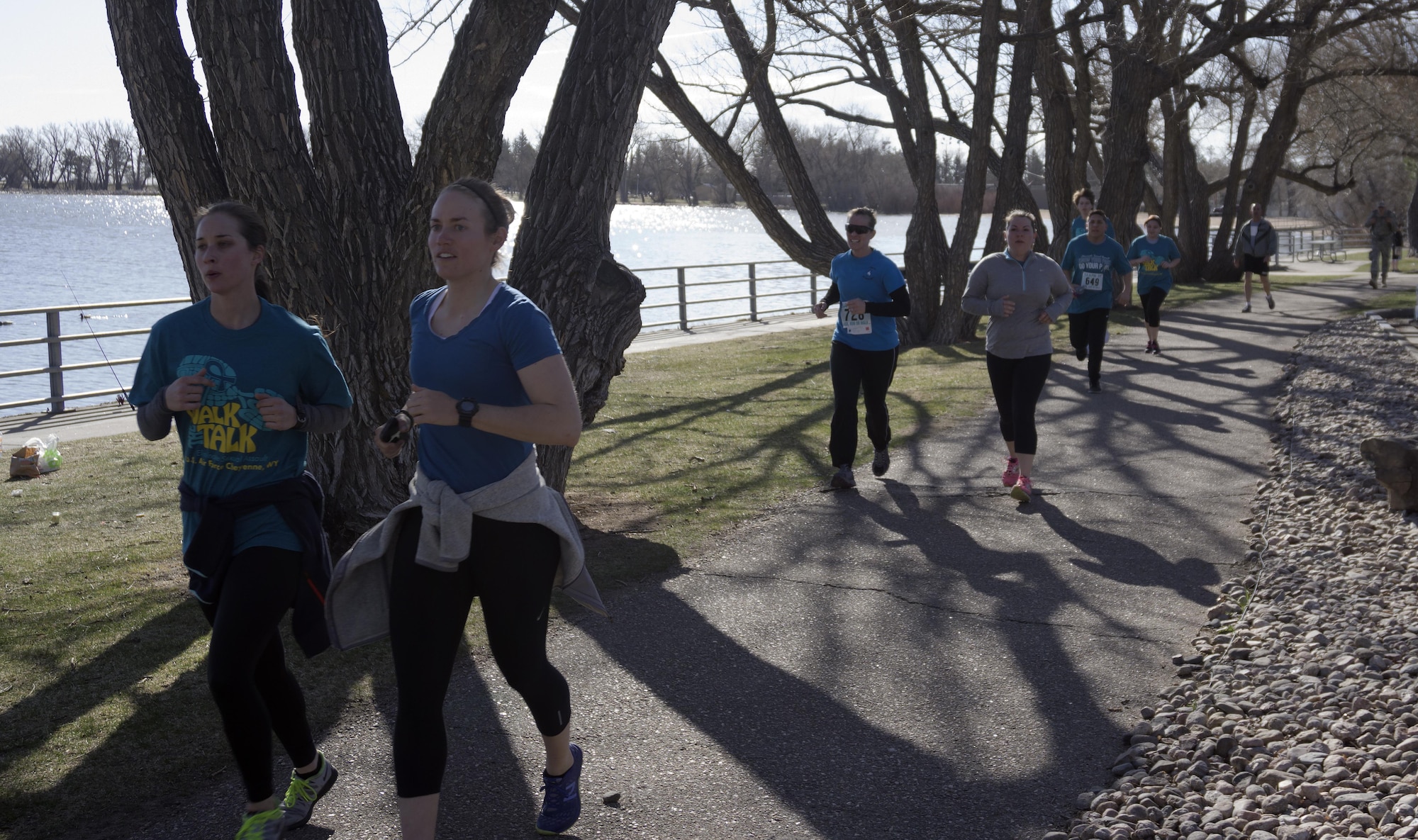 Runners follow the course around Sloan’s Lake in Lion’s Park, Cheyenne, Wyo., during the Sexual Assault Awareness 5- kilometer race April 9, 2016. More than 500 participants – Airmen, Soldiers, Guardsmen and community members – ran, walked and ruck-marched the course. (U.S. Air Force photo by Senior Airman Brandon Valle)