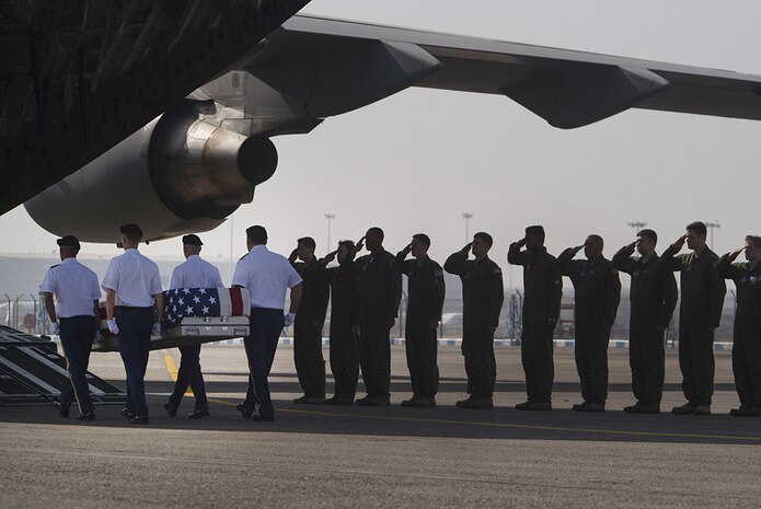 A U.S. Air Force C-17 aircrew salutes as U.S Army Soldiers from the Defense POW/MIA Accounting Agency (DPAA) conduct a repatriation ceremony of possible American remains in New Delhi, India, Apr. 13, 2016. Secretary of Defense Ash Carter attended the ceremony during his visit to India.  The remains that were turned over to DPAA are possibly related to a 1940's Army Air Force aircrew crash that occurred in India. 