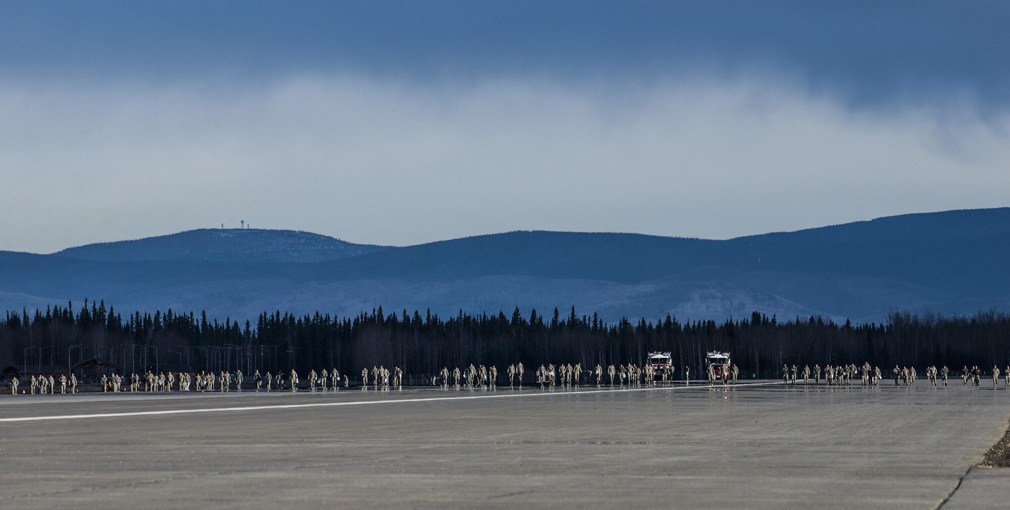 Airmen from Eielson Air Force Base, Alaska, conduct a wing-wide foreign-object debris (FOD) walk, April 11, 2016, to remove materials from the runway that could damage an aircraft during a takeoff or landing. Approximately 800 Airmen from the 354th Fighter Wing and tenant units covered five and a half miles of Eielson’s taxiways and runways in preparation for RED-FLAG-Alaska. (U.S. Air Force photo by Staff Sgt. Joshua Turner/Released)