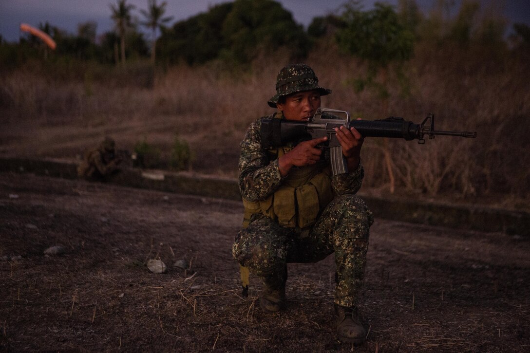 Philippine Marine Cpl. Mark De-Guzman takes part in a patrol with the U.S. Marine Corps during Balikatan 16, Panay, Philippines, April 11, 2016. De-Guzman is with the Marine Battalion Landing Team 4. Throughout Balikatan, U.S. and Philippine Marines exchanged tactics, techniques and procedures to hone their combined readiness. This year marks the 32nd iteration of Balikatan where U.S. service members continue to work “shoulder-to-shoulder” with members of the Armed Forces of the Philippines to increase combined readiness to crises and conflict across the Indo-Asia-Pacific region. (U.S. Marine Corps photo by Lance Cpl. Jessica N. Etheirdge/Released)