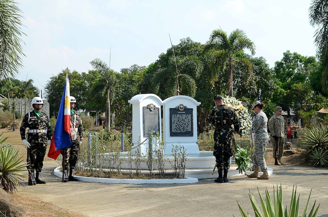 Soldiers from 445th Civil Affairs Battalion and Filipino soldiers from 7th Infantry Division, Armed Forces of the Philippines lay a wreath at the Cabanatuan POW Memorial, April 11, 2016. 