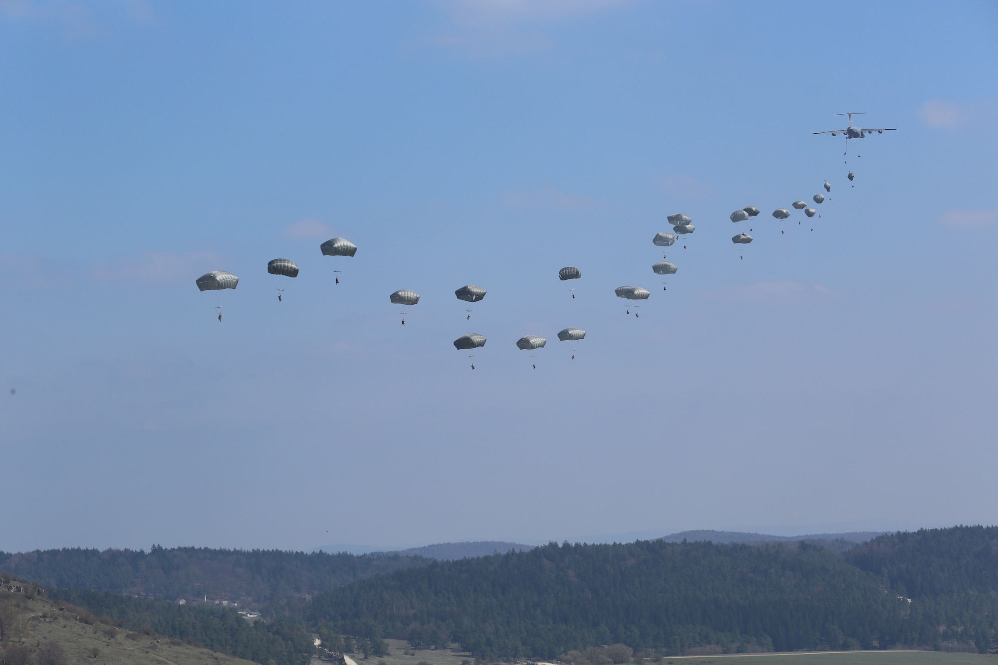 U.S. Soldiers of the 173rd Airborne Brigade jump from a Boeing C-17 Globemaster III while conducting an airborne operation during exercise Saber Junction 16 at the U.S. Army’s Joint Multinational Readiness Center (JMRC) in Hohenfels, Germany, April 11, 2016. Saber Junction 16 is the U.S. Army Europe’s 173rd Airborne Brigade’s combat training center certification exercise, taking place at the JMRC in Hohenfels, Germany, Mar. 31-Apr. 24, 2016. The exercise is designed to evaluate the readiness of the Army’s Europe-based combat brigades to conduct unified land operations and promote interoperability in a joint, multinational environment. Saber Junction 16 includes nearly 5,000 participants from 16 NATO and European partner nations. (U.S. Army Photo by Pfc. Gage Hull/Released)