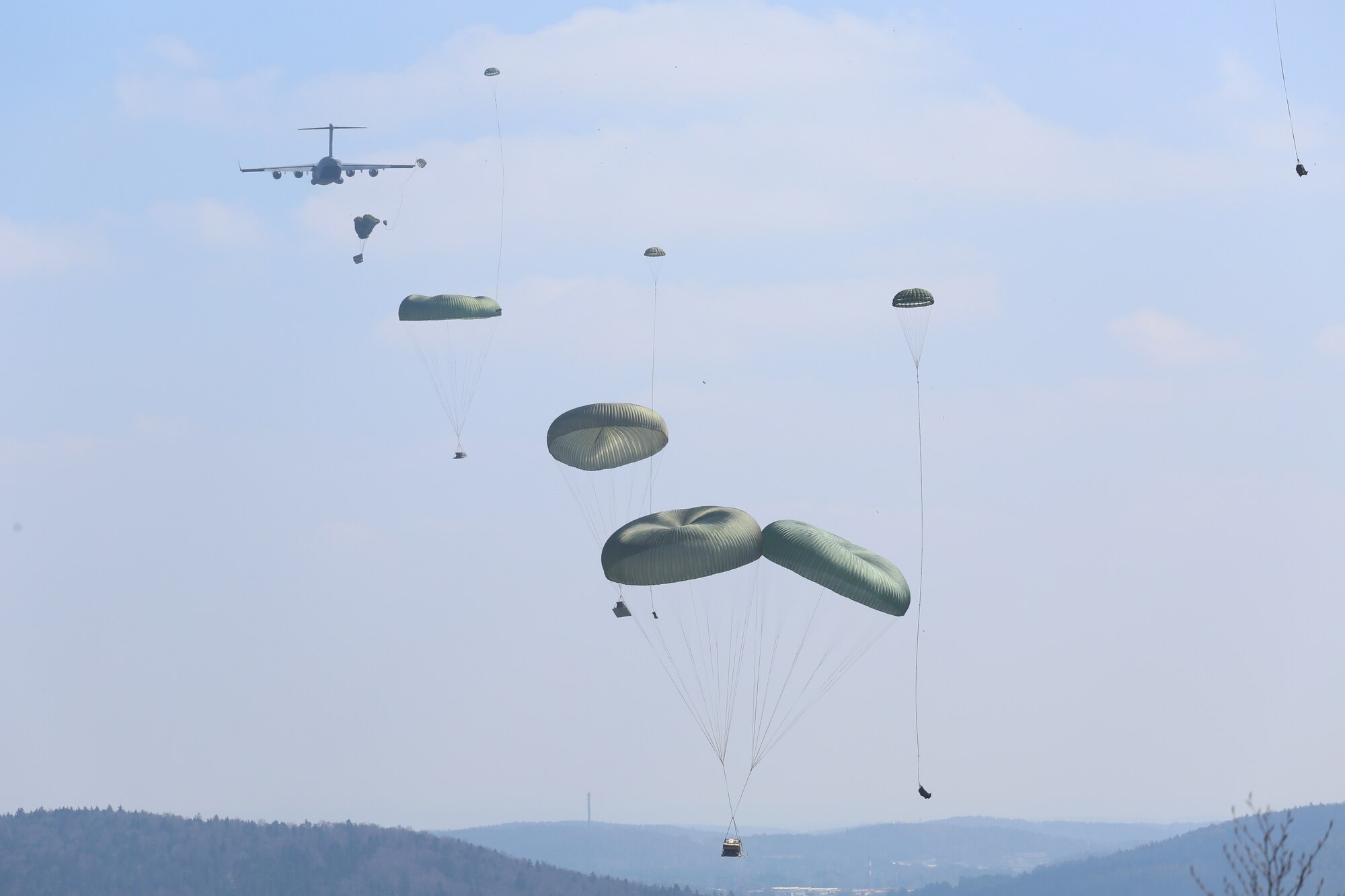 U.S. Soldiers of the 173rd Airborne Brigade release a heavy drop from a Boeing C-17 Globemaster III while conducting an airborne operation during exercise Saber Junction 16 at the U.S. Army’s Joint Multinational Readiness Center (JMRC) in Hohenfels, Germany, April 11, 2016. Saber Junction 16 is the U.S. Army Europe’s 173rd Airborne Brigade’s combat training center certification exercise, taking place at the JMRC in Hohenfels, Germany, Mar. 31-Apr. 24, 2016. The exercise is designed to evaluate the readiness of the Army’s Europe-based combat brigades to conduct unified land operations and promote interoperability in a joint, multinational environment. Saber Junction 16 includes nearly 5,000 participants from 16 NATO and European partner nations. (U.S. Army Photo by Pfc. Gage Hull/Released)