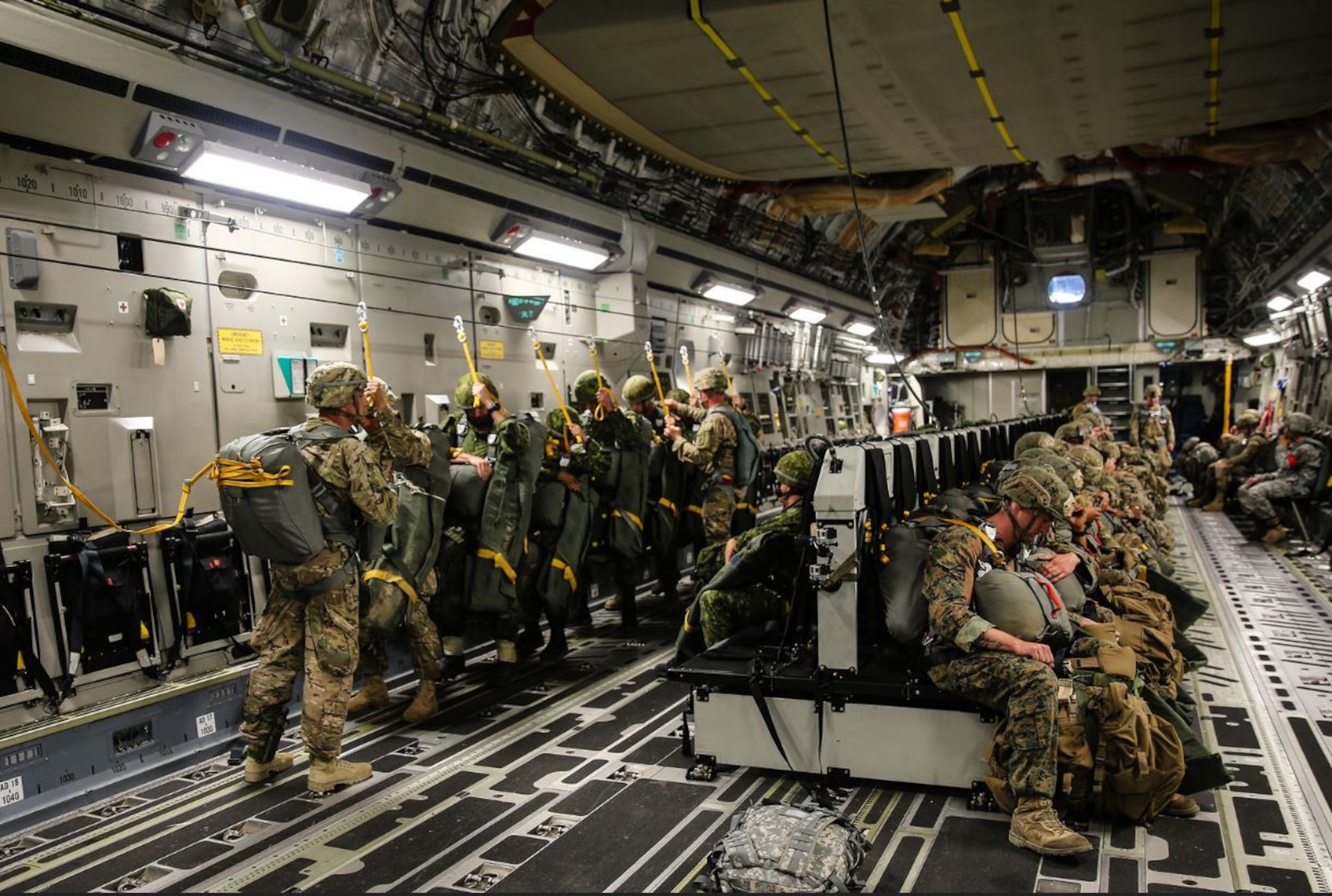 U.S. Army Soldiers and NATO service members participate in a personnel drop during Saber Junction 16, April 12, 2016, at Aviano Air Base, Italy. The exercise involved the 173rd Airborne Brigade and 16 allied and European nations conducting land operations in a joint, combined environment and to promote interoperability with participating nations. (U.S. Air Force photo by Airman 1st Class Cory W. Bush/Released)