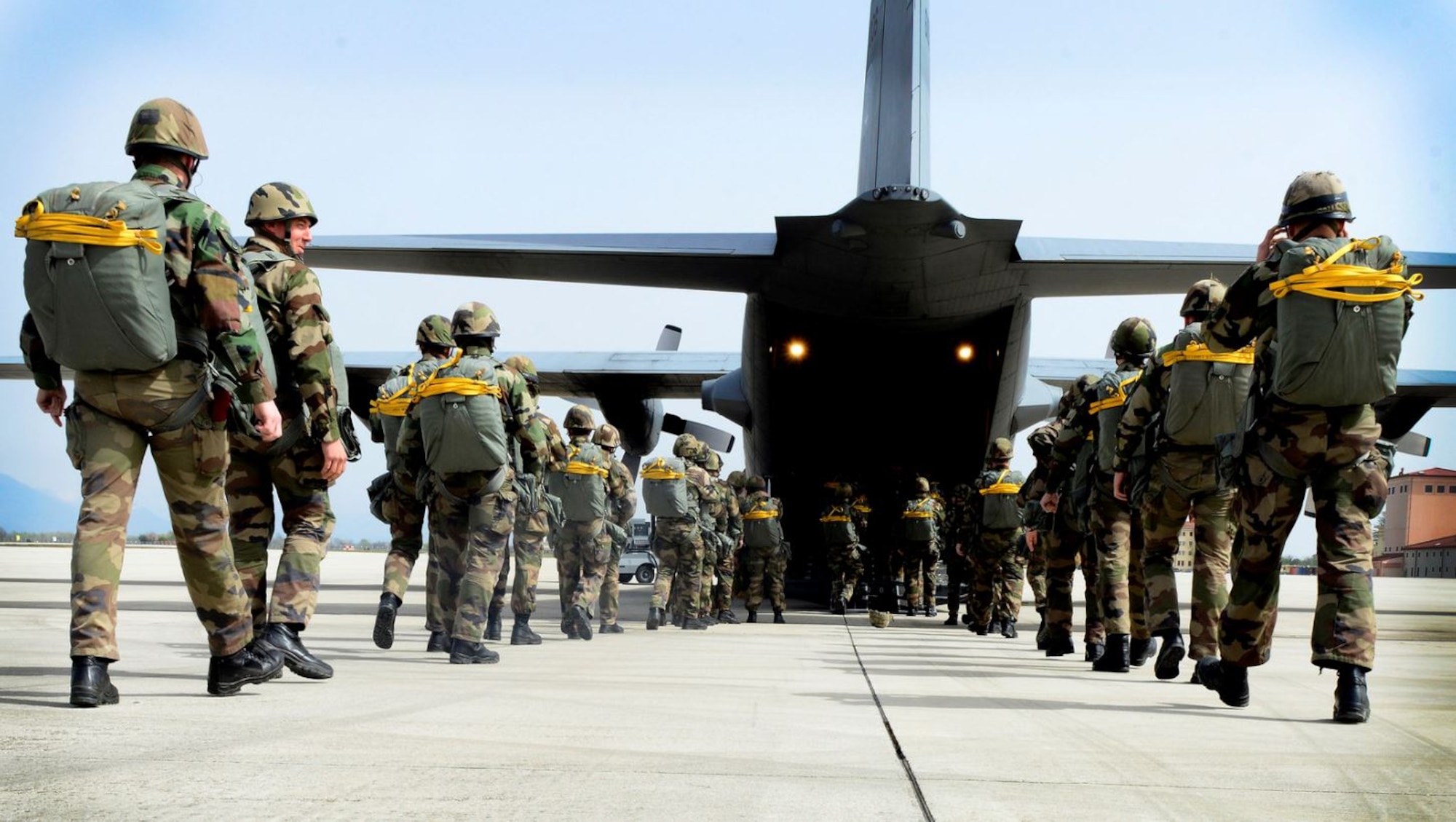 NATO service members prepare for a jump exchange prior to Saber Junction 16, April 5, 2016, at Aviano Air Base, Italy. The exercise involved the 173rd Airborne Brigade and 16 allied and European nations conducting land operations in a joint, combined environment and to promote interoperability with participating nations. (U.S. Air Force photo by Senior Airman Areca T. Bell/Released)