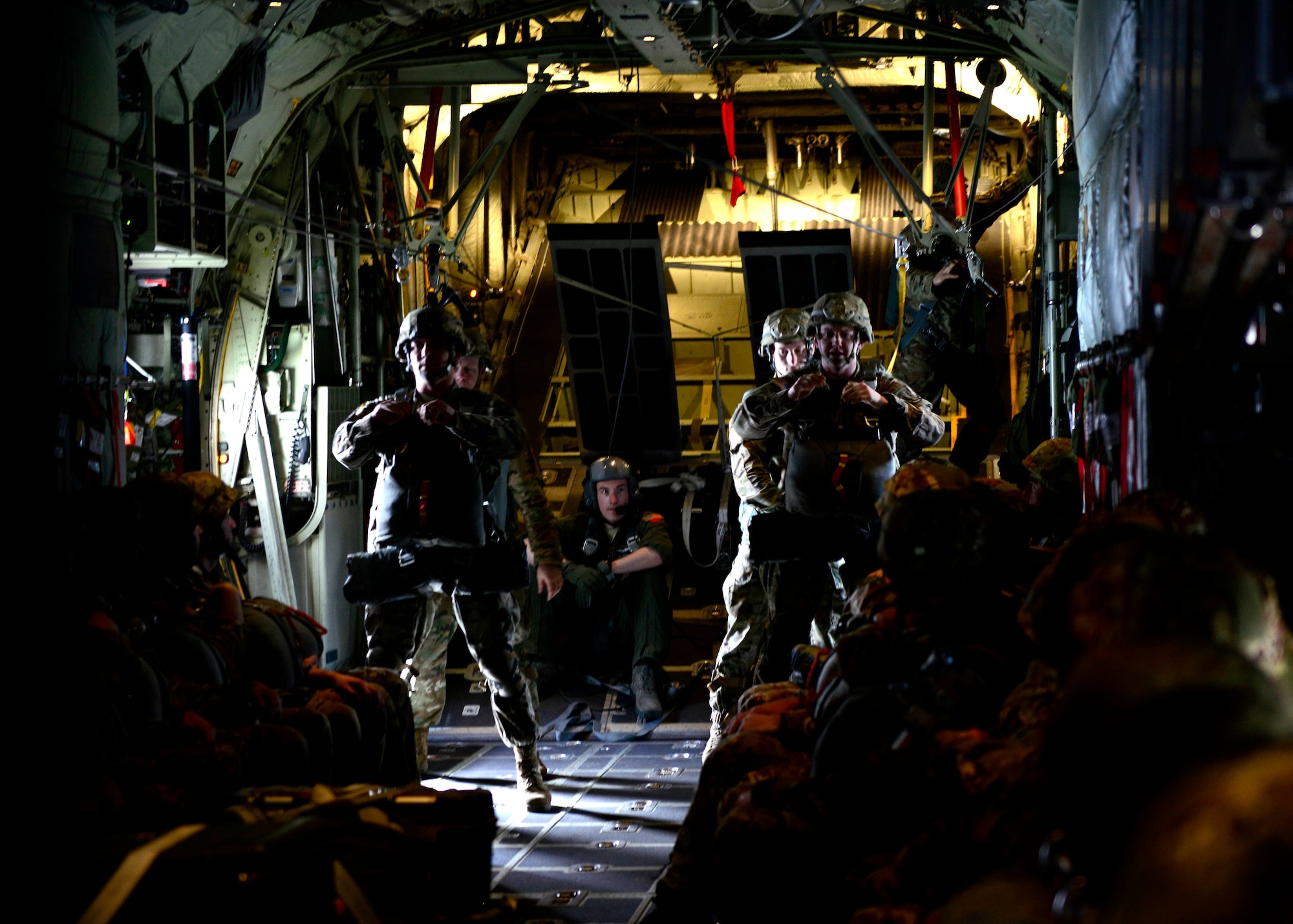 NATO service members prepare for a jump exchange prior to Saber Junction 16, April 5, 2016, at Aviano Air Base, Italy. The exercise involved the 173rd Airborne Brigade and 16 allied and European nations conducting land operations in a joint, combined environment and to promote interoperability with participating nations. (U.S. Air Force photo by Senior Airman Areca T. Bell/Released)