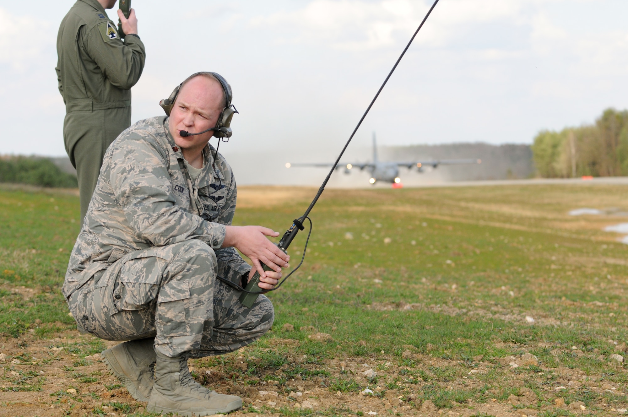 U.S. Air Force Maj. Aaron Cook, an Air Mobility Liaison Officer (AMLO) to 2nd Calvary Regiment at the Joint Multinational Training Command awaits the takeoff of a Minnesota Air Guard C-130 during air-land operations in support of Saber Junction 16, April 6, 2016. The exercise, held at the Joint Multinational Readiness Center in Hohenfels, Germany, Mar. 31-April 24, 2016, is designed to evaluate the readiness of the U.S. Army Europe’s 173rd Airborne Brigade to conduct unified land operations and promote interoperability in a joint, multinational environment. Saber Junction 16 includes nearly 5,000 participants from 16 NATO and European partner nations. (U.S. Army photo taken by Pvt. Kourtney Grimes)
