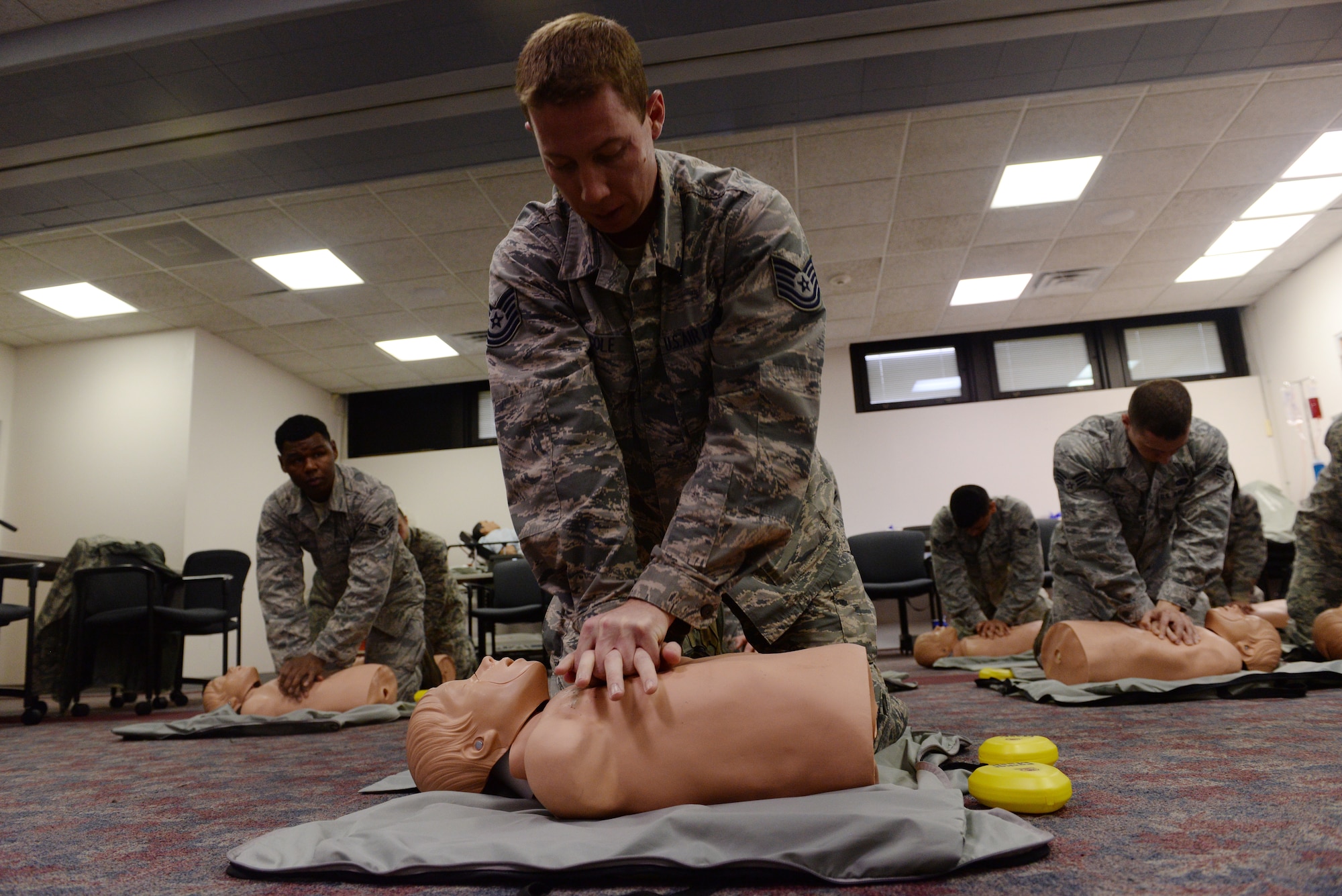 Tech. Sgt. Jeremy Cole, 375th Operations Support Squadron Airfield Systems technician, practices chest compressions during a basic life support class at the 375th Medical Group clinic April 6, 2016. The BSL class taught students how to use CPR and an automated external defibrillator on a person suffering from cardiac arrest. (U.S. Air Force photo by Staff Sgt. Maria Bowman) 