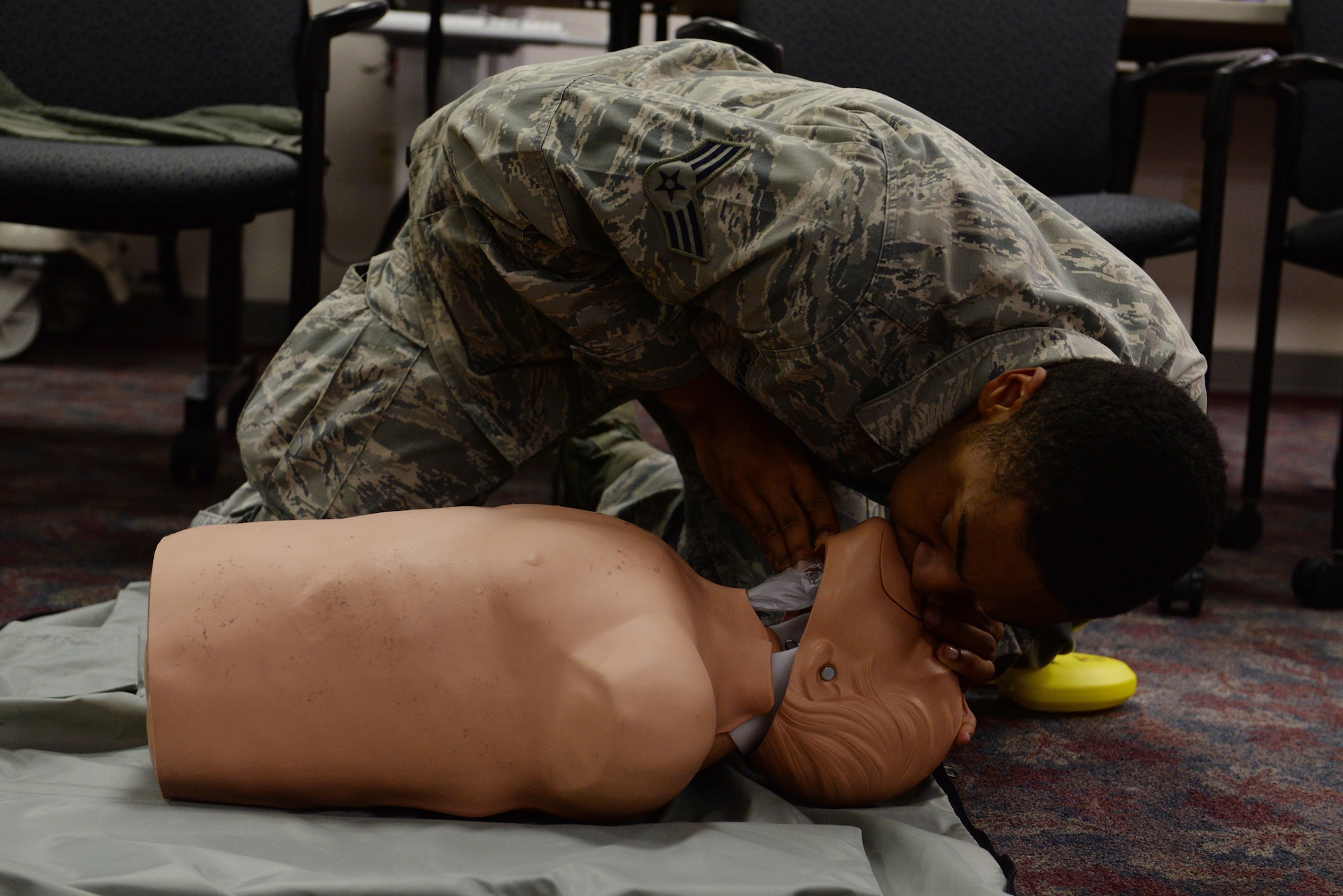 Senior Airman Sheldon Crawford, 375th Security Forces Squadron Combat Arms instructor, practices CPR during a basic life support class at the 375th Medical Group clinic April 6, 2016. The class attendees learned how to give chest compressions and blow air into the lungs of a non-responsive person. (U.S. Air Force photo by Staff Sgt. Maria Bowman) 