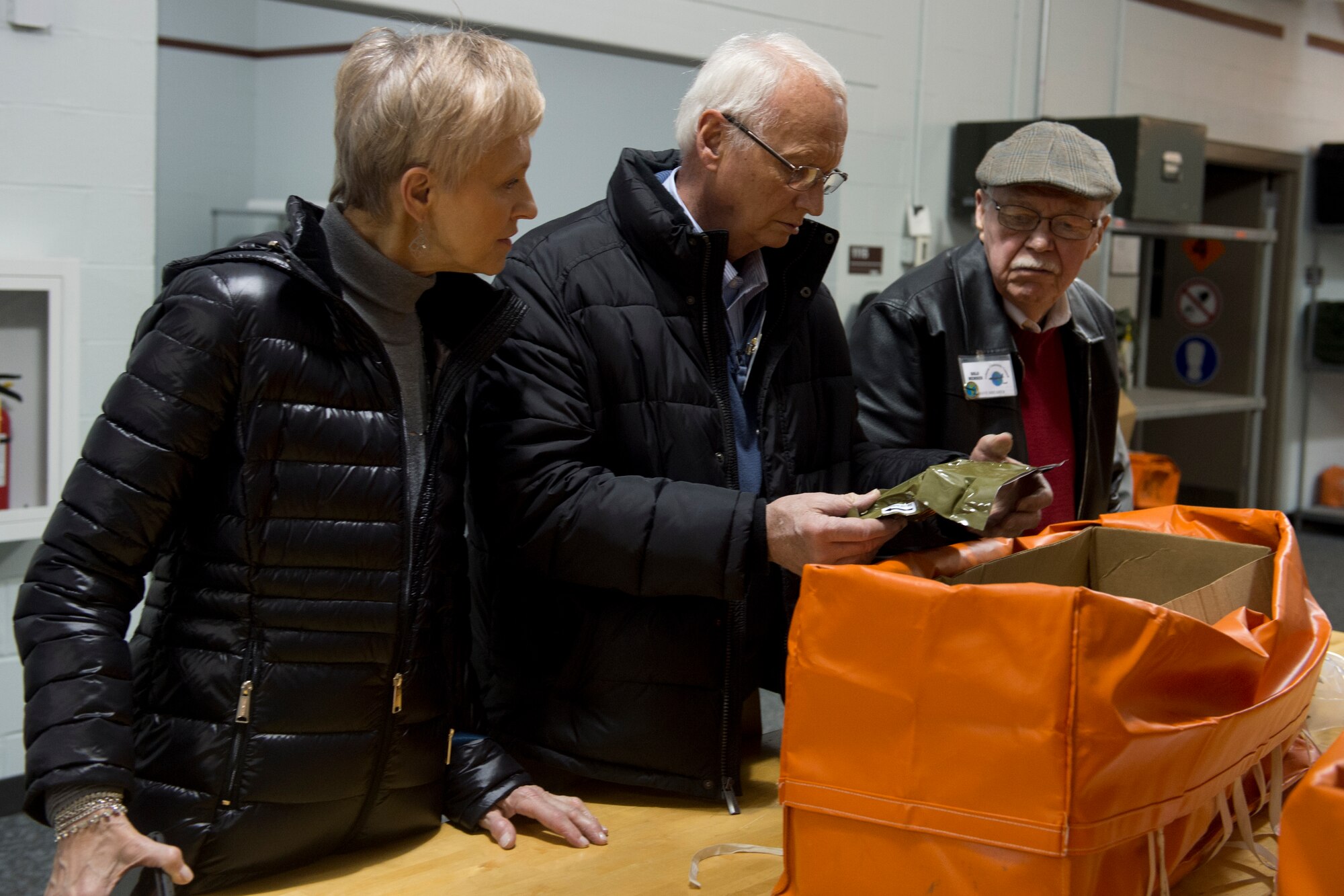 Grissom Community Council members Barbara and William Taylor and David Shearer examine supplies which can be used by aircrew in an emergency during an immersion event hosted by the 434th Operations Group at Grissom Air Reserve Base, Ind., April 8, 2016. During the event local leaders were given the opportunity to visit the air traffic control tower, examine aircrew flight equipment and experience Grissom’s KC-135R flight simulator. (U.S. Air Force photo/Senior Airman Dakota Bergl)