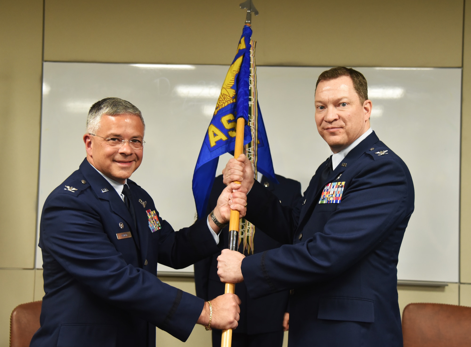 After promoting to the rank of Colonial during a ceremony just before, Gary Hopkins (right), was given command of the 927th Aeromedical Staging Squadron by Col. Randy Bright, commander, 927th Air Refueling Wing, April 2, 2015. Hopkins was serving as the interim commander before officially taking command during the April Unit Training Assembly.  (U.S. Air Force photo by Staff Sgt. Adam C. Borgman)