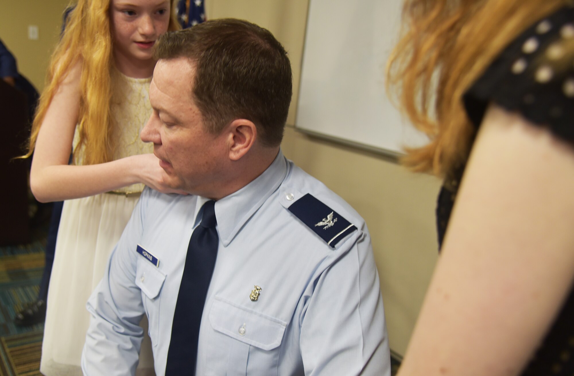 Prior to an assumption of command ceremony for the 927th Aeromedical Staging Squadron, Gary Hopkins’ daughters got to pin on the rank of Colonel on to their dad, April 2, 2015. Hopkins has been the interim commander prior to officially taking command in front of the men and woman of this squadron. (U.S. Air Force photo by Staff Sgt. Adam C. Borgman)