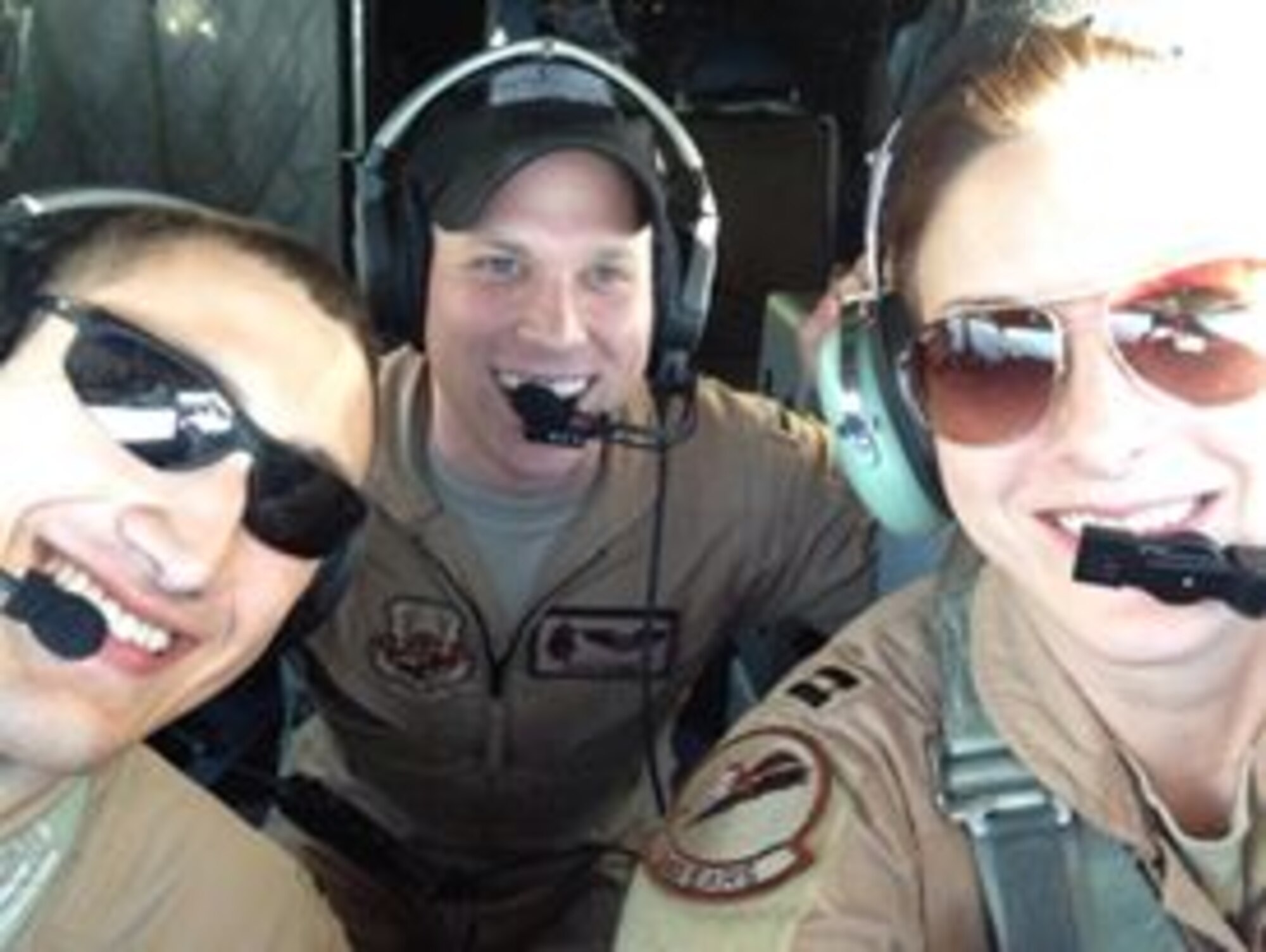 First Lt. Ryan Cobb, center, 384th Air Refueling Squadron navigator, poses for a photo, April 2014 during a deployment. (Courtesy photo)