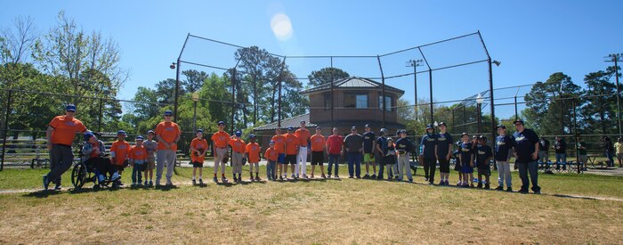 Volunteers and players with the Challenger Division take a group photo April 9, 2016, at the youth baseball fields on Joint Base Charleston – Air Base, S.C. The Challenger Division is a league that was established to enable boys and girls with physical and mental challenges to enjoy the game of baseball along with other children who share the same challenges. (U.S. Air Force photo/Senior Airman Clayton Cupit)