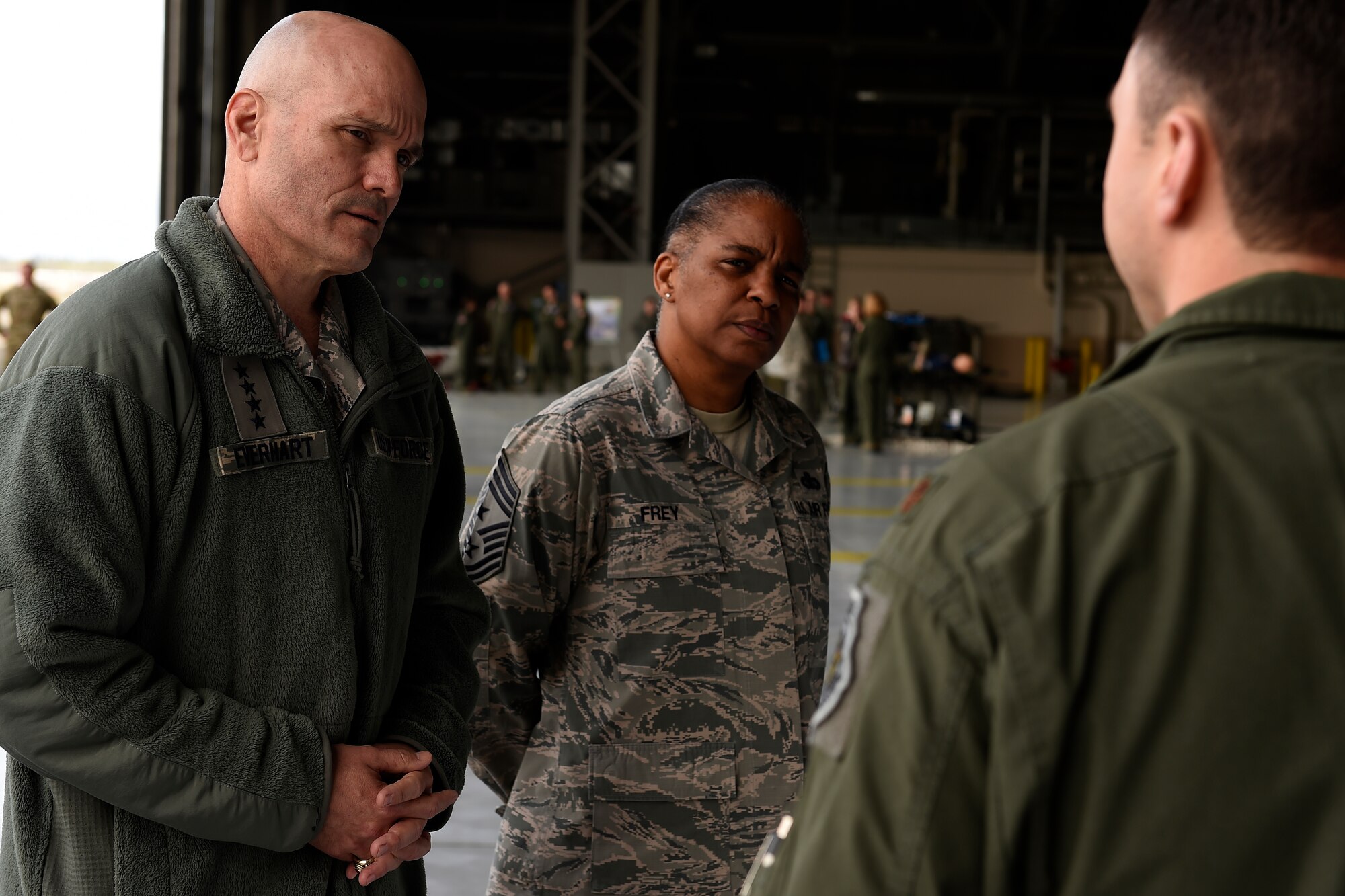 Gen. Carlton D. Everhart II, Air Mobility Command commander and Chief Master Sgt. Shelina Frey, AMC chief, talk with Maj. Sean McConville, 62nd Operations Support Squadron tactics director, at Joint Base Lewis-McChord, Wash. April, 5, 2016. McConville briefed about readiness and training. (U.S. Air Force photo/Tech. Sgt. Tim Chacon)
