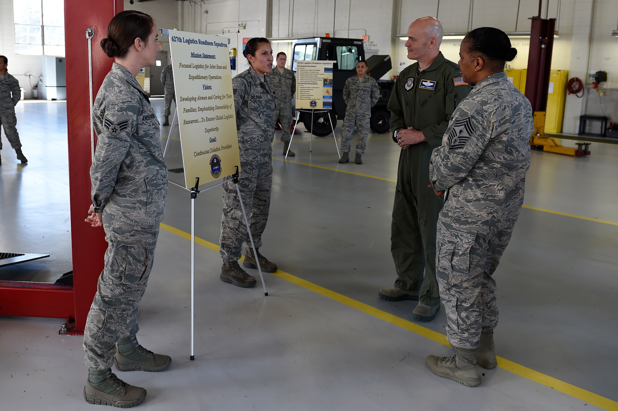 Airmen from the 627th Logistic Readiness Squadron brief Gen. Carlton D. Everhart II, Air Mobility Command commander, and Chief Master Sgt. Shelina Frey, AMC command chief, at Joint Base Lewis-McChord, Wash. April, 6, 2016. Everhart and Frey meet with several units of the 627th Air Base Group to talk about their importance to the mission of AMC. (U.S. Air Force photo/Tech. Sgt. Tim Chacon)