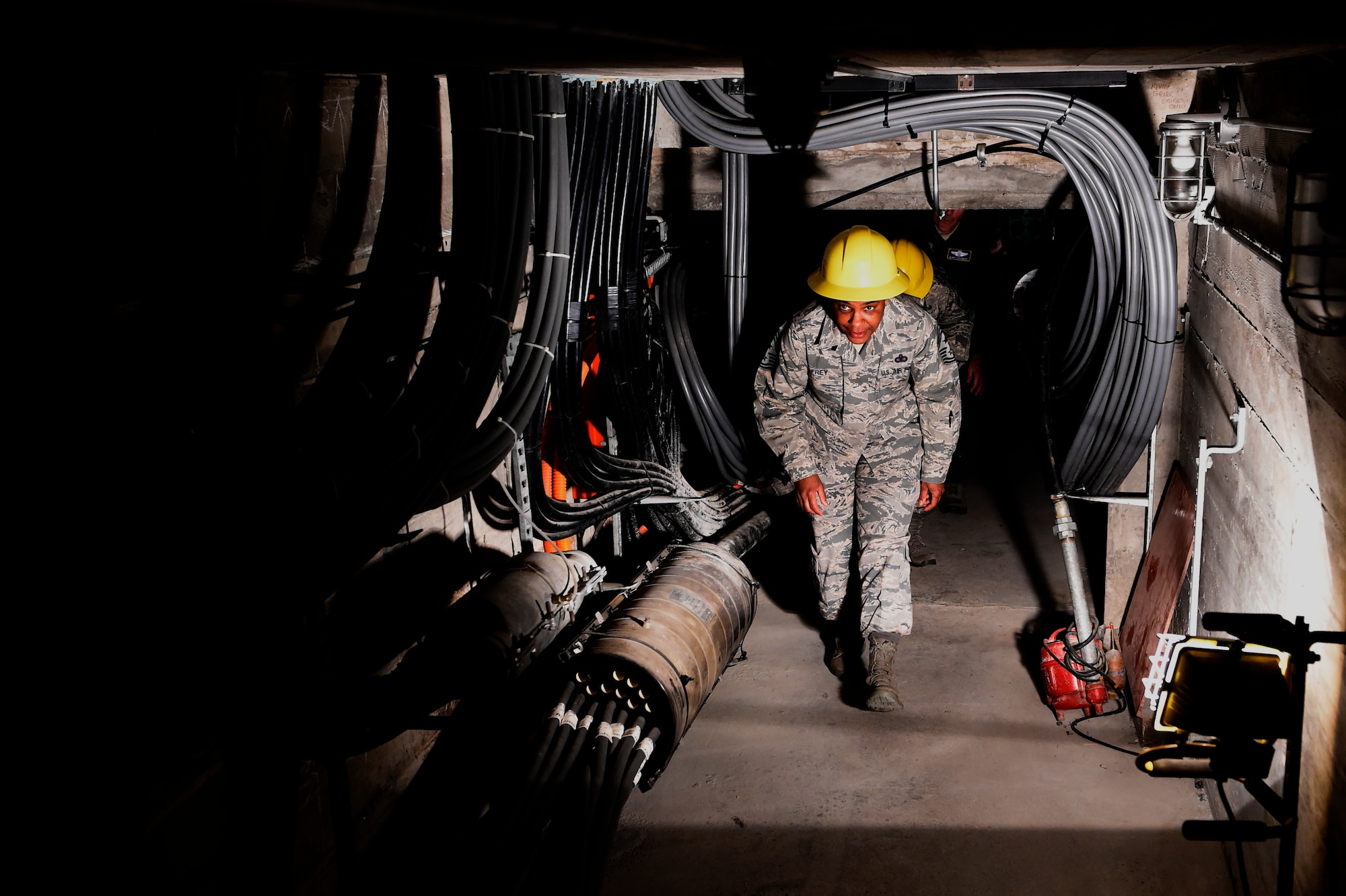 Chief Master Sgt. Shelina Frey, Air Mobility Command command chief, tours 627th Communication Squadron tunnels at Joint Base Lewis-McChord, Wash. April, 6, 2016. The 627th CS provides most telephone, computer and internet support for McChord Field. (U.S. Air Force photo/Tech. Sgt. Tim Chacon)