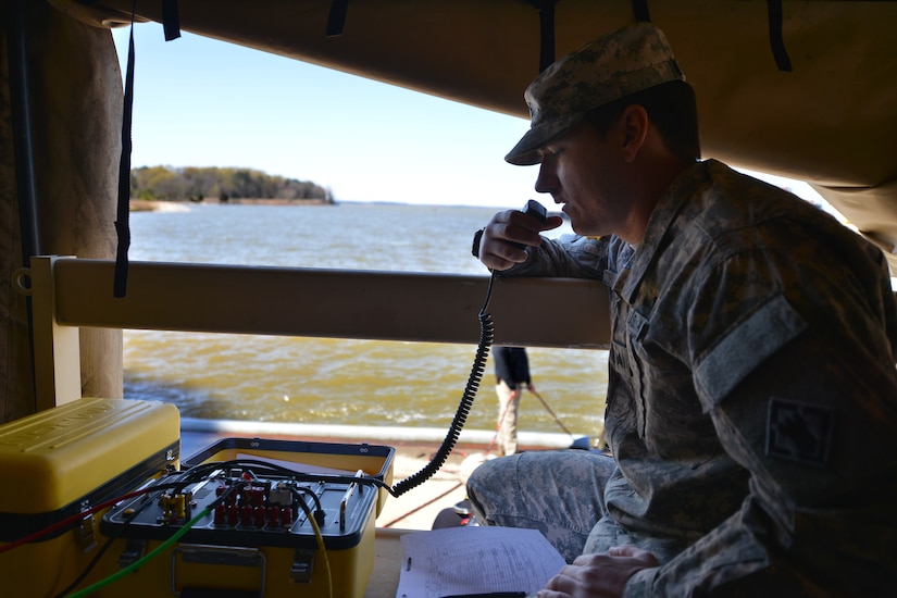 U.S. Army Sgt. Kiley Bannan, a salvage diver assigned to the 569th Engineer Dive Detachment, uses surface-dive equipment to communicate with a submerged diver at Fort Eustis, Va., March 22, 2016. Divers use surface-dive equipment for long dives that require constant communication, and head and eye protection. (U.S. Air Force photo by Staff Sgt. Natasha Stannard)