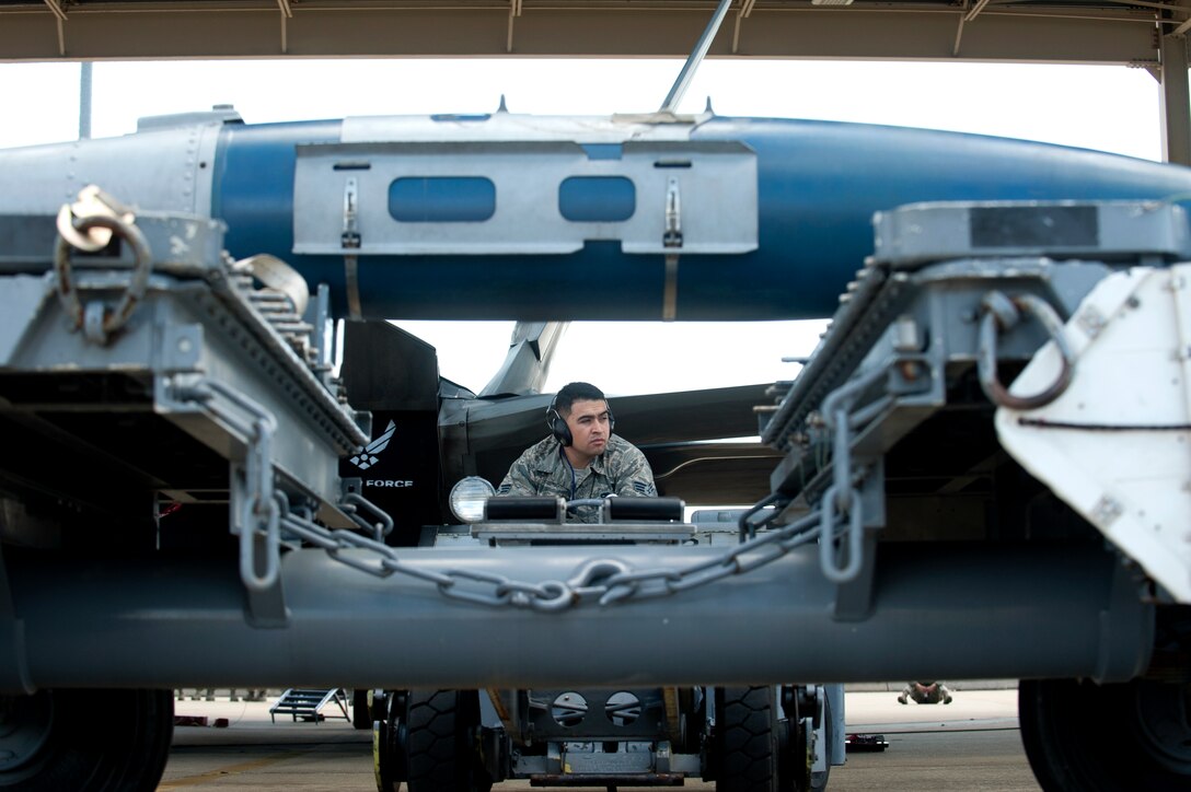 U.S. Air Force Senior Airman Uriel Romero, a weapons load crew member 27 Aircraft Maintenance Unit, prepares to move a GBU-32 Joint Direct Attack Munition during the Second Quarter Weapons Load competition at Langley Air Force Base, Va., April 8, 2016. During the quarterly competition, three-person teams from the 27th and 94th AMUs competed to load two AIM-9 missiles and the GBU-32 the fastest, while maintaining the fewest errors possible. (U.S. Air Force photo by Senior Airman R. Alex Durbin/Released)