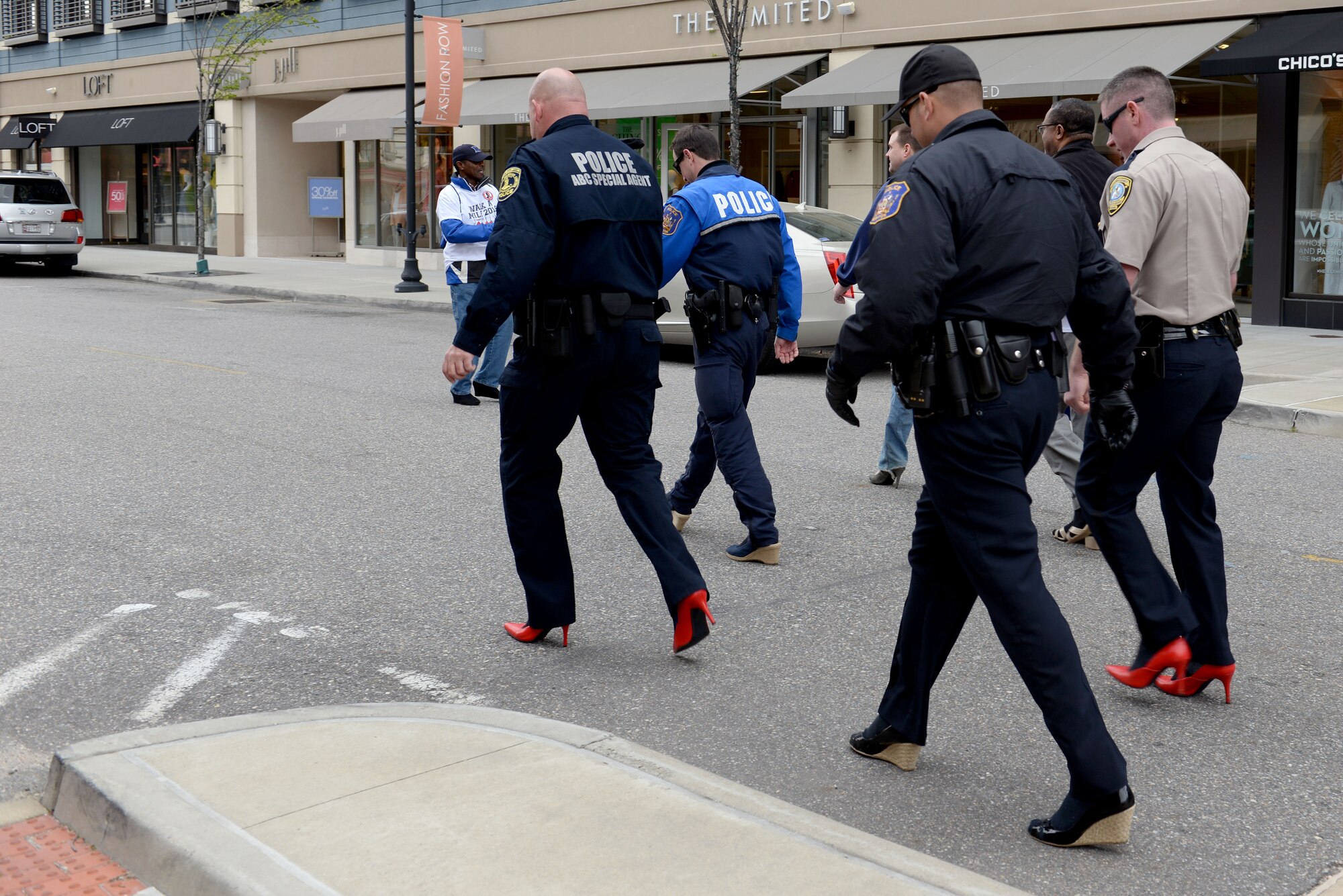 Members of the Hampton Police Division walk in the “Walk a Mile in Her Shoes” event in Hampton, Va., April 9, 2016. According to the National Sexual Violence Resource Center, 63 percent of sexual assaults are not reported to the police.  (U.S. Air Force photo by Airman 1st Class Kaylee Dubois)