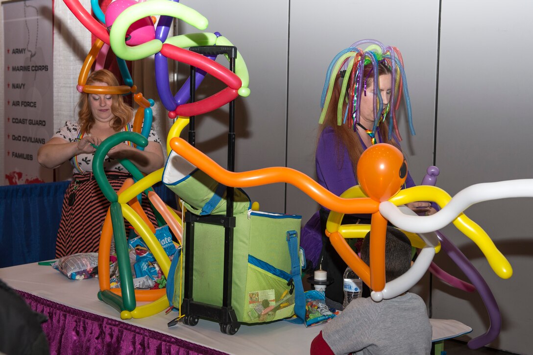 Volunteers create balloon hats during the “Seussabration” event in Hampton, Va., April 9, 2016. The event was held to celebrate military children during the Month of the Military Child. (U.S. Air Force photo by Airman 1st Class Derek Seifert)