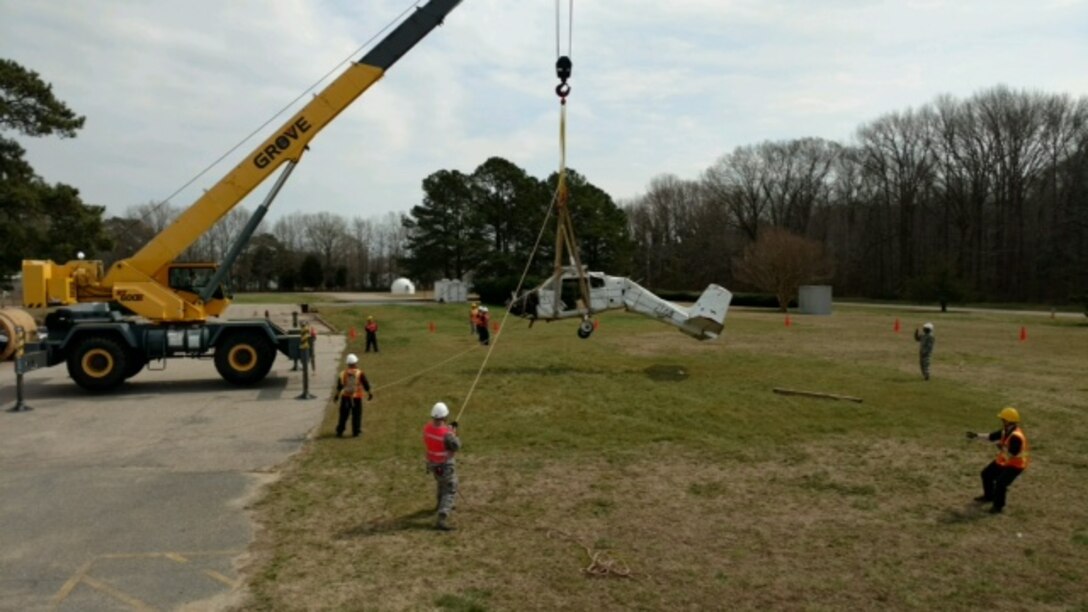 U.S. Air Force Airmen assigned to the 27th Aircraft Maintenance Squadron Crash Disabled Damaged Aircraft Recovery (CDDAR) team practice using cranes to properly move a crashed Cessna airplane during an exercise March 11, 2016 at Joint Base Langley-Eustis, Va. The exercise provided the CDDAR team hands-on experience with the necessary tools to respond to an aircraft mishap. (Courtesy photo)