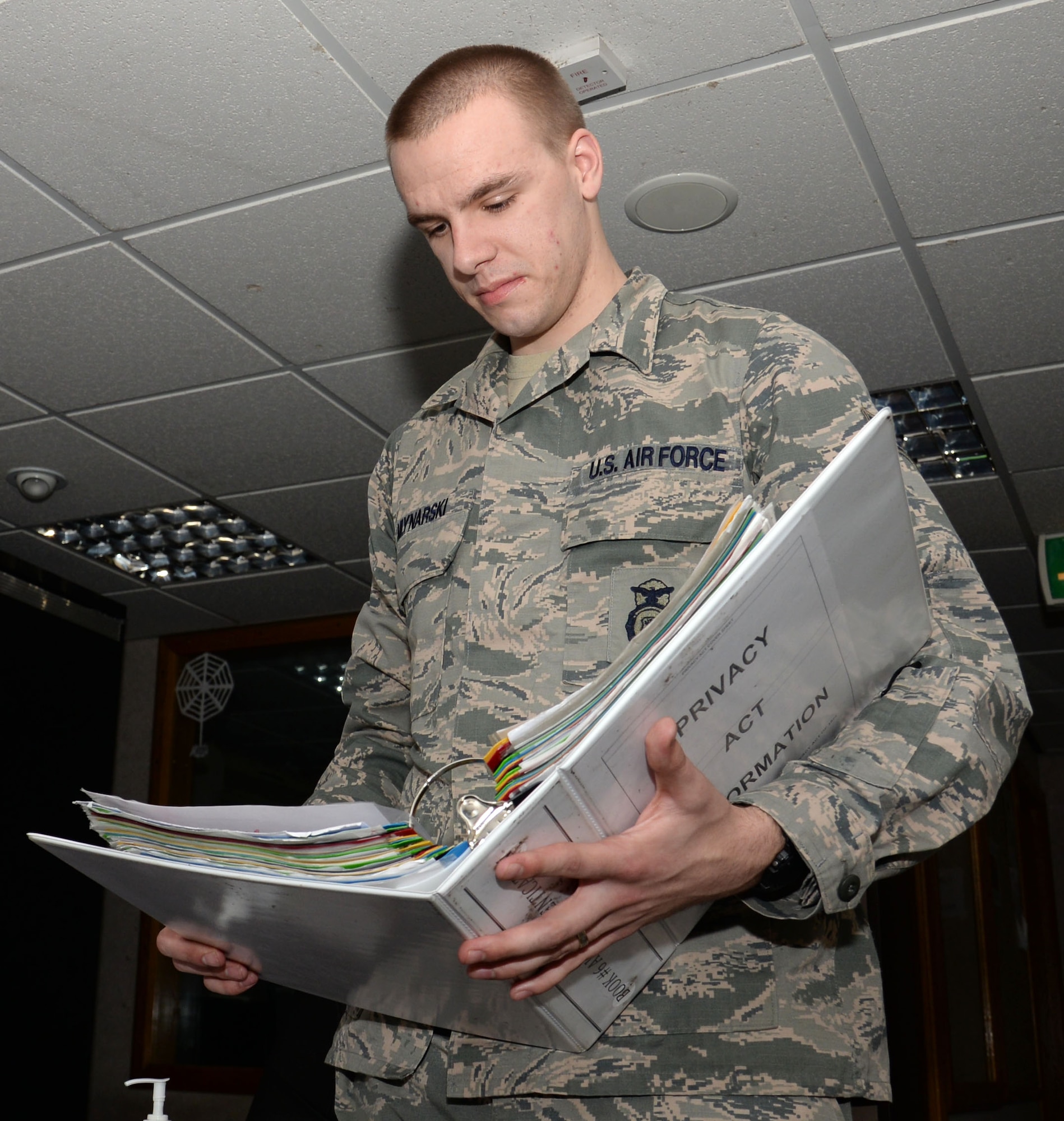 U.S. Air Force Senior Airman Niklas Mlynarski, 100th Security Forces Squadron combined controller, looks through checklists, March 21, 2016, on RAF Mildenhall, England. The unit won the award for 2015's Best Large Security Forces Squadron for USAFE-AFAFRICA. (U.S. Air Force photo by Gina Randall/Released)