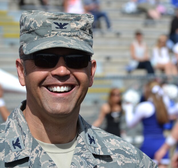 Col. Anthony Mastalir, 50th Space Wing vice commander, smiles following an opening-play touchdown pass during the U.S. Air Force Academy Blue-Silver game at Fountain-Fort Carson High School, Saturday, April 9, 2016. Mastalir, along with other commanders from Front Range installations, served as an honorary coach during the annual intrasquad scrimmage. (U.S. Air Force photo/Brian Hagberg)