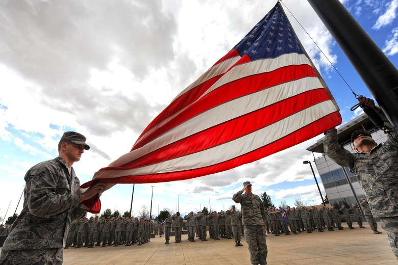 Airmen with the 50th Space Wing conduct this year’s first spring retreat ceremony at Schriever Air Force Base, Colorado, Thursday, April 7, 2016. The wing holds reveille or retreat monthly to show its respect to the Stars and Stripes. (U.S. Air Force photo/Dennis Rogers)
