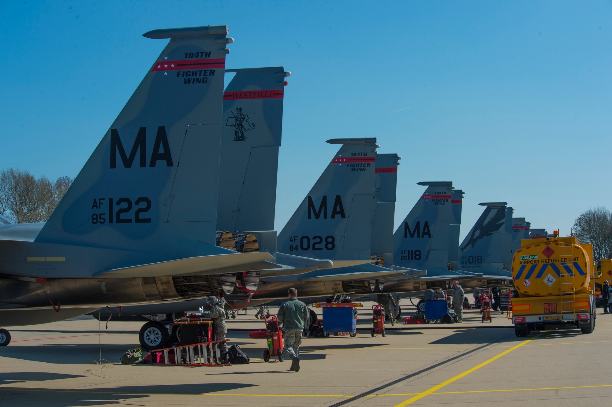 The tail fins of U.S. Air Force F-15C Eagle fighter aircraft assigned to the 131st Expeditionary Fighter Squadron remain parked on a flightline during a theater security package deployment at Leeuwarden Air Base, Netherlands, April 11, 2016. The F-15s represented a theater security package rotation, which began in the European theater in 2015 to reassure NATO allies and partner nations of the U.S. commitment to the security and stability of Europe. (U.S. Air Force photo by Staff Sgt. Joe W. McFadden/Released)