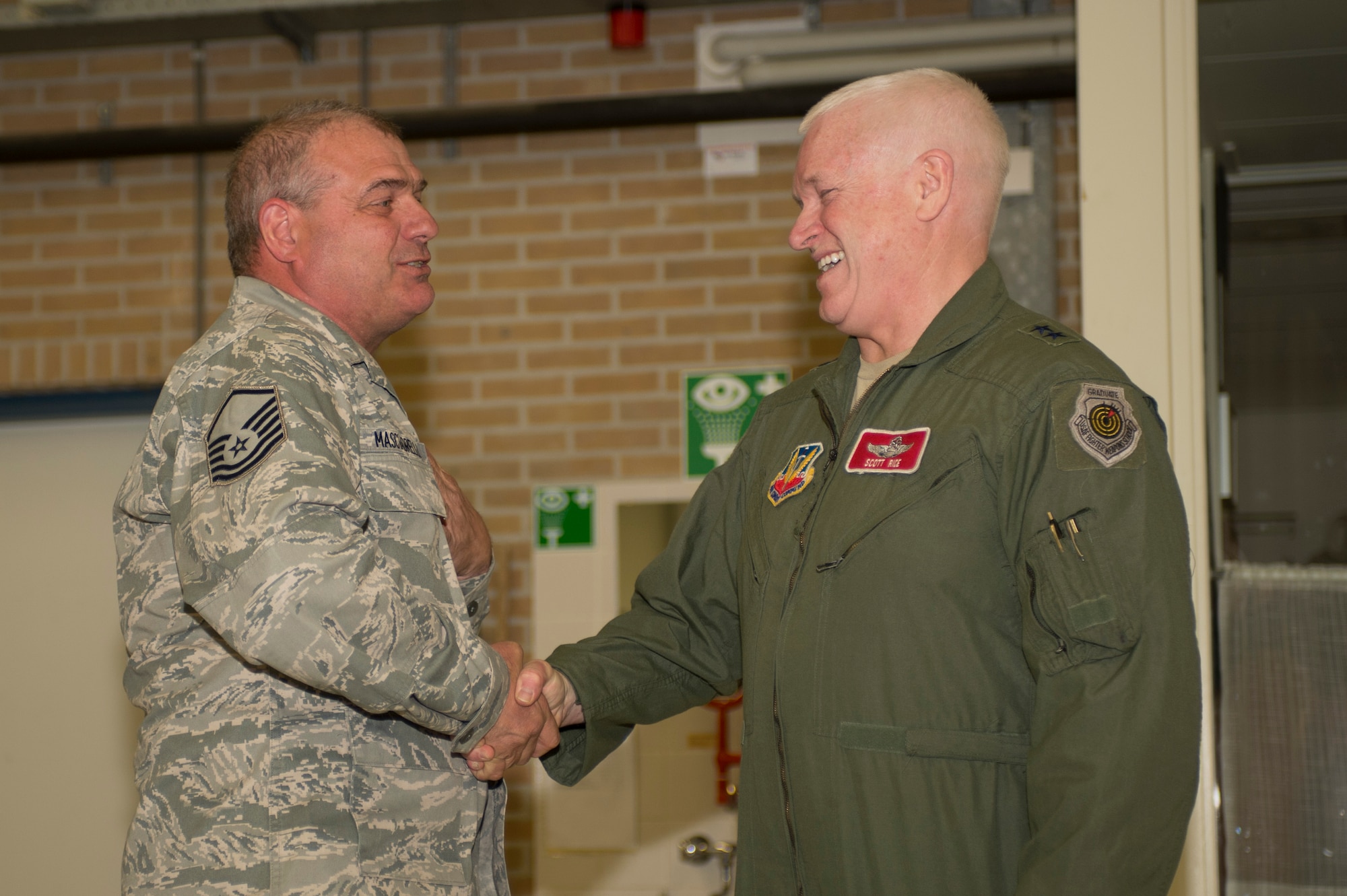 U.S. Air Force Maj. Gen. Scott Rice, Massachusetts National Guard adjutant general, right, shakes the hand of U.S. Air Force and Massachusetts Air National Guard Master Sgt. Donald Masciadrelli, a 104th Maintenance Squadron avionics technician and Montgomery, Mass., native, during a theater security package deployment at Leeuwarden Air Base, Netherlands, April 12, 2016. Rice coined Masciadrelli for excellence as part of his deployment in support of Operation Atlantic Resolve. (U.S. Air Force photo by Staff Sgt. Joe W. McFadden/Released)