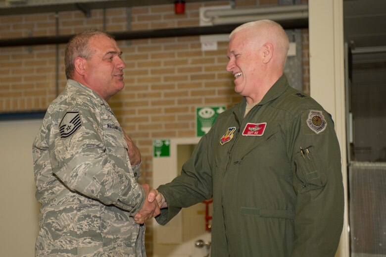 U.S. Air Force Maj. Gen. Scott Rice, Massachusetts National Guard adjutant general, right, shakes the hand of U.S. Air Force and Massachusetts Air National Guard Master Sgt. Donald Masciadrelli, a 104th Maintenance Squadron avionics technician and Montgomery, Mass., native, during a theater security package deployment at Leeuwarden Air Base, Netherlands, April 12, 2016. Rice coined Masciadrelli for excellence as part of his deployment in support of Operation Atlantic Resolve. (U.S. Air Force photo by Staff Sgt. Joe W. McFadden/Released)