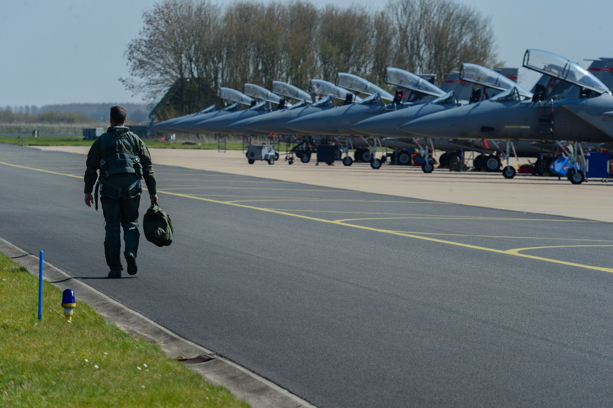 A U.S. Air Force 131st Expeditionary Fighter Squadron F-15C Eagle fighter aircraft pilot walks down the flightline to his aircraft during a theater security package deployment at Leeuwarden Air Base, Netherlands, April 11, 2016. The squadron will complete a six-month deployment through Europe aimed at reassuring NATO allies and partner nations about the U.S.’s commitment to a European continent that is whole, free and at peace. (U.S. Air Force photo by Staff Sgt. Joe W. McFadden/Released)