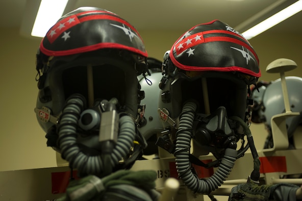 Two helmets belonging to 131st Expeditionary Fighter Squadron F-15C Eagle fighter aircraft pilots rest on posts inside an aircrew flight equipment room during a theater security package deployment at Leeuwarden Air Base, Netherlands, April 11, 2016. The 131th EFS deployed to Europe to strengthen interoperability between NATO allies and to demonstrate U.S. commitment to the security and stability of Europe. (U.S. Air Force photo by Staff Sgt. Joe W. McFadden/Released)