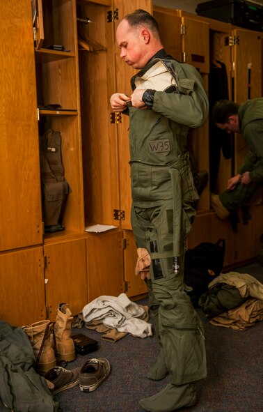 A 480th Fighter Squadron pilot suits up before the 480th FS deployment in the squadron’s locker room at Spangdahlem Air Base, Germany, April 7, 2016. The 480th FS tasked their pilots to deploy to Southwest Asia in support of Operation Inherent Resolve. (U.S. Air Force photo by Airman 1st Class Timothy Kim/Released)