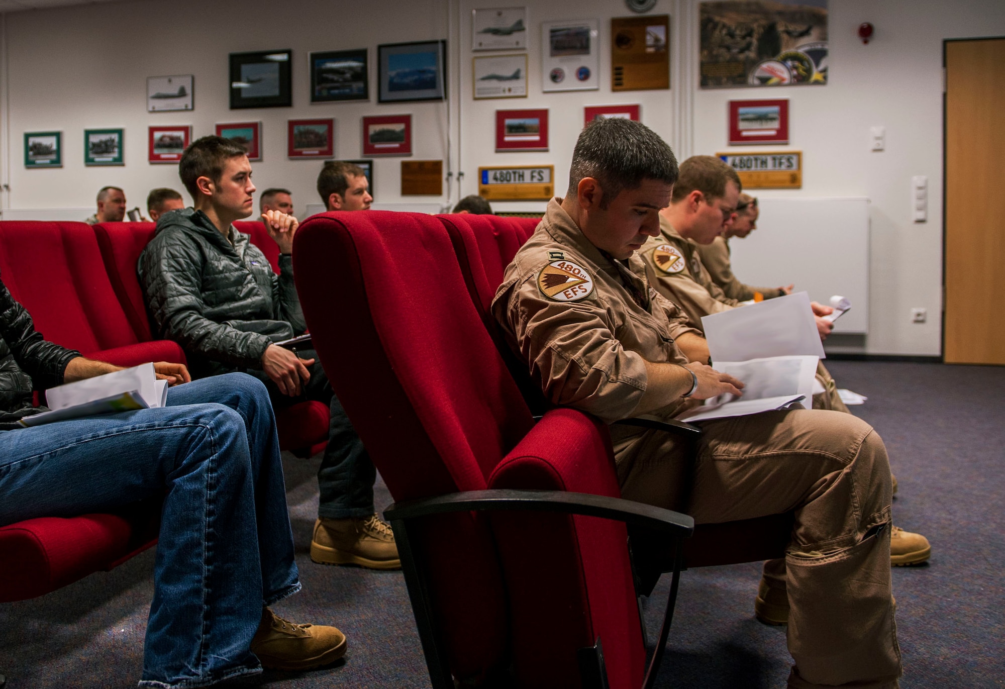 Pilots from the 480th Fighter Squadron attend a briefing in the squadron’s conference room before their deployment at Spangdahlem Air Base, Germany, April 7, 2016. The 480th FS deployed to Southwest Asia in support of Operation Inherent Resolve. (U.S. Air Force photo by Airman 1st Class Timothy Kim/Released)