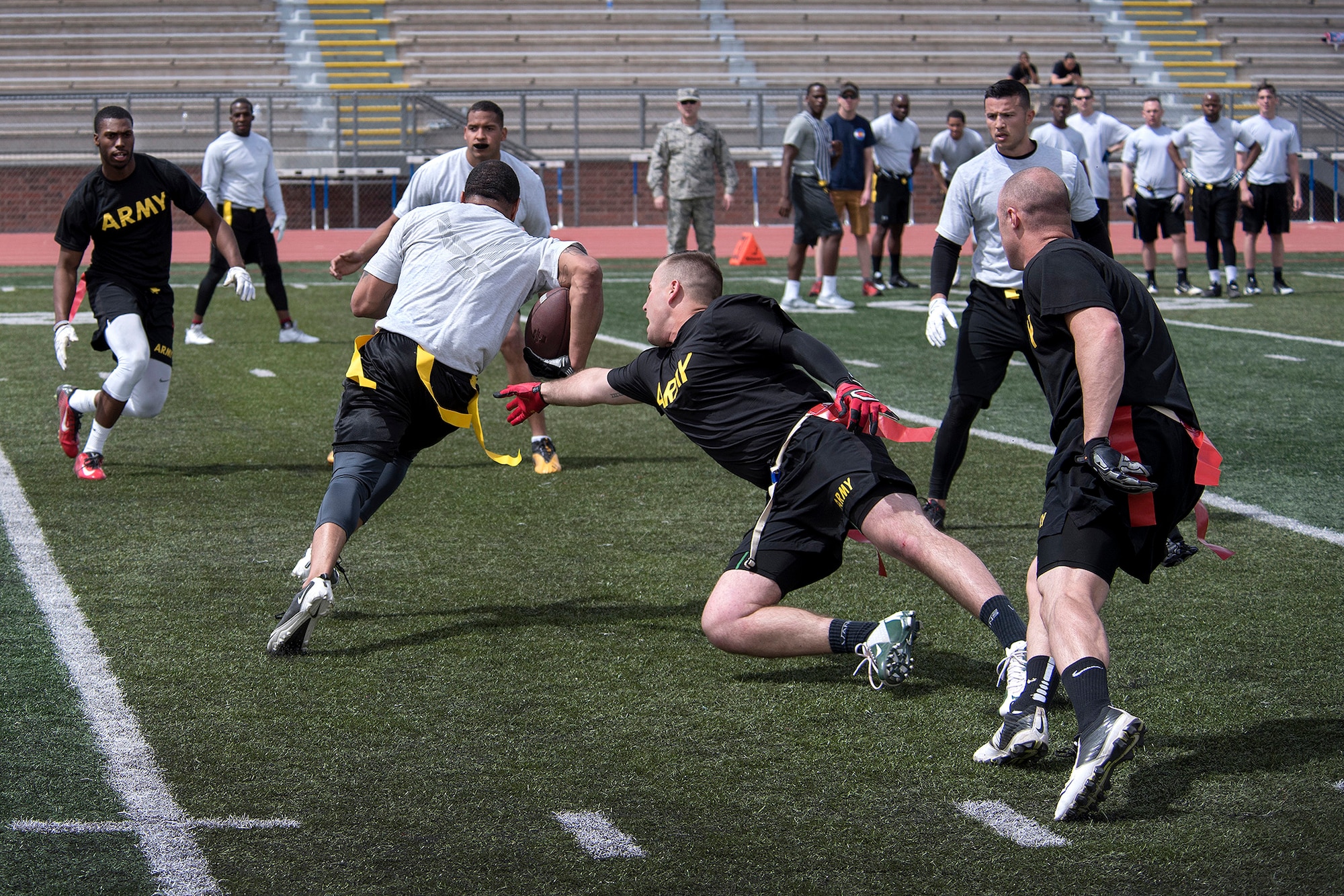 COLORADO SPRINGS, Colo. – Soldiers from Fort Carson and Airmen from Peterson/Schriever Air Force Base’ battle on the field during a flag football game at Falcon-Fort Carson High School on April 9, 2016. The game followed an inter-squad practice scrimmage with United States Air Force Academy Falcons football team. (U.S. Air Force Photo by Craig Denton)

