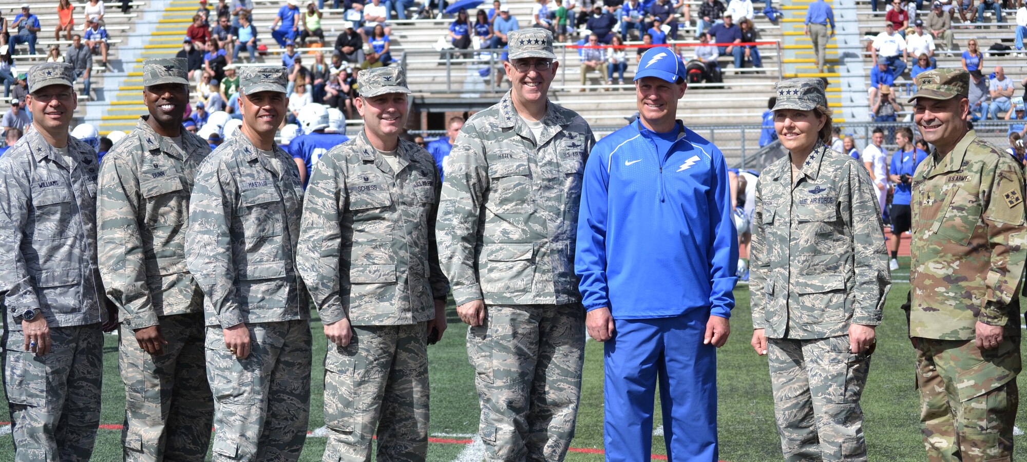 COLORADO SPRINGS, Colo. - Brig. Gen. Stephen Williams, U.S. Air Force Academy commandant of cadets; Col. Troy Dunn, 10th Air Base Wing commander; Col. Anthony Mastalir, 50th Space Wing vice commander; Col. Douglas Schiess, 21st Space Wing commander; Gen. John Hyten, commander Air Force Space Command; Troy Calhoun, USAFA head football coach; Lt. Gen. Michelle Johnson, USAFA superintendent; and Maj. Gen. Ray Gonsalves, 4th Infantry Division and Fort Carson commanding general, pose following the coin toss for the Blue-Silver game at Fountain-Fort Carson High School, Saturday, April 9, 2016. The commanders served as honorary coaches during the annual intrasquad scrimmage, with the Air Force contingent leading the offense, while the Army commanders led the defense. (U.S. Air Force photo/Brian Hagberg)