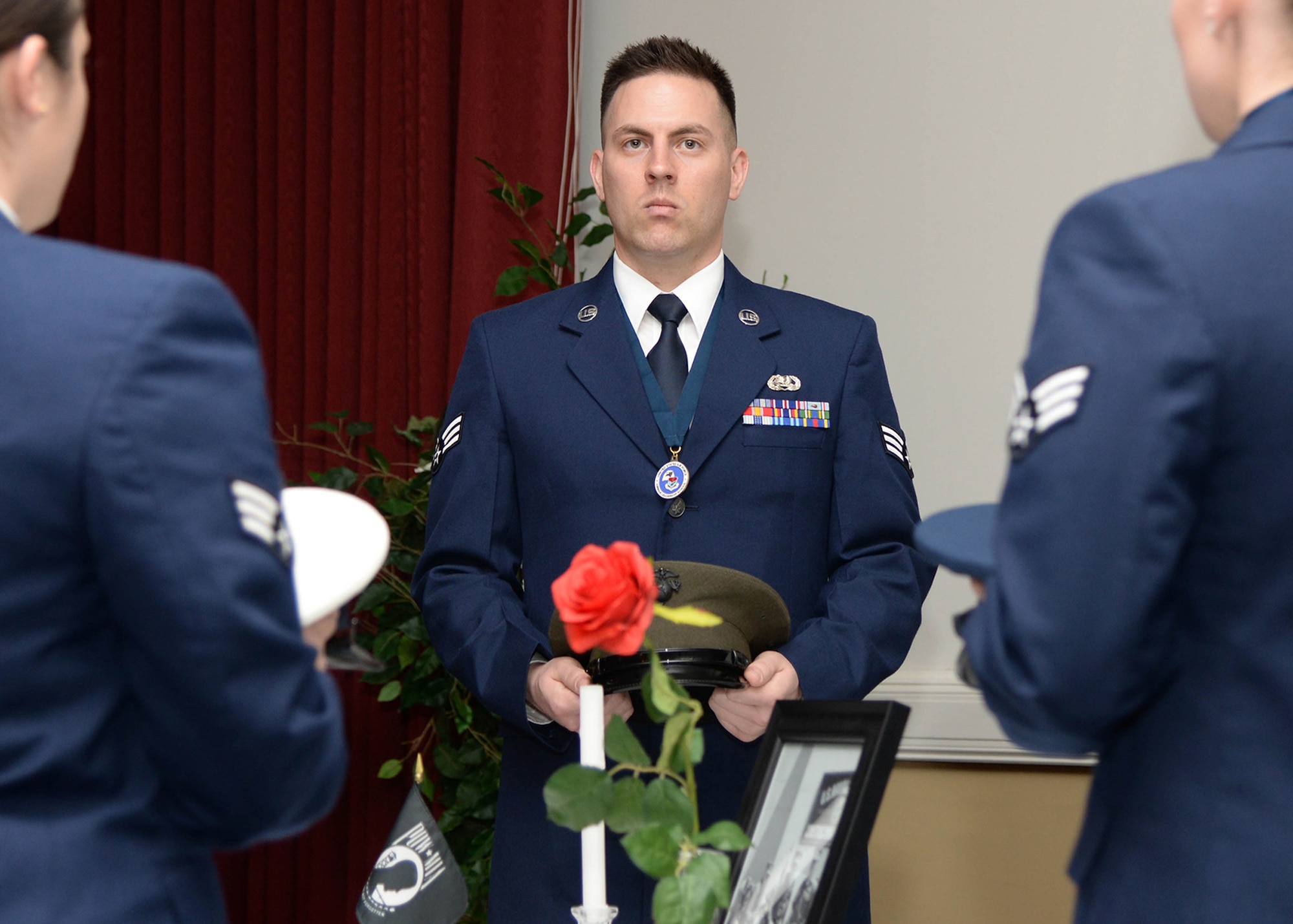 Senior Airman Russell T. Grantham participates in a POW/MIA ceremony as part of a presentation during an Airman Leadership School graduation banquet at the Minuteman Commons April 8. The class, comprised of nine senior airmen and two U.S. Coast Guard petty officers, completed the first step in their professional military education following completion of the five-week course. (U.S. Air Force photo by Linda LaBonte Britt)