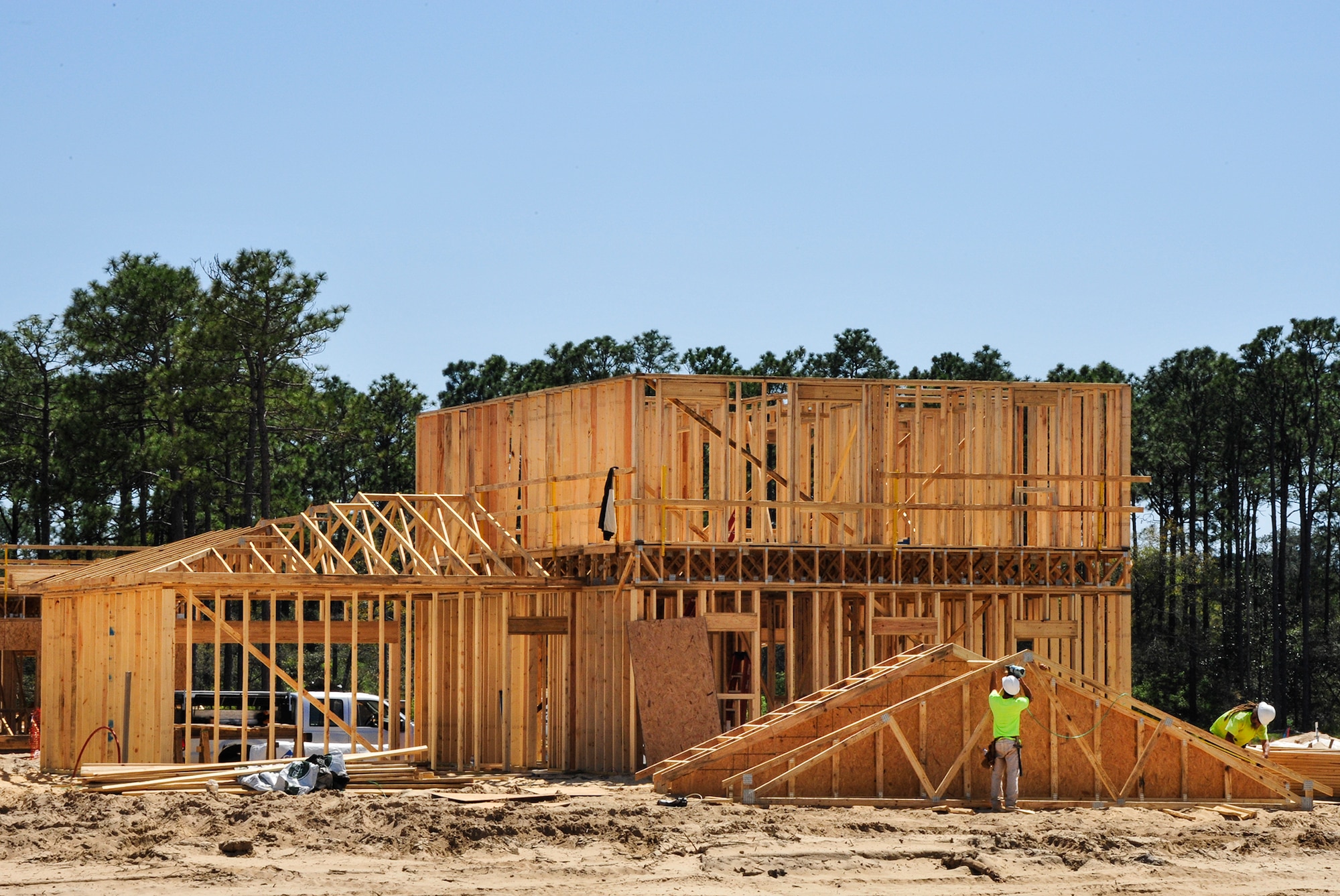 Construction workers make progress on one of the 747 privatized homes being built on Eglin Air Force Base, Fla., April 7. The new development will include multiple playgrounds, a dog-friendly “bark” park, a community center with a fitness room, and a pool. The entire community is estimated to be completed by 2019. (U.S. Air Force Photo/Jasmine Porterfield)
