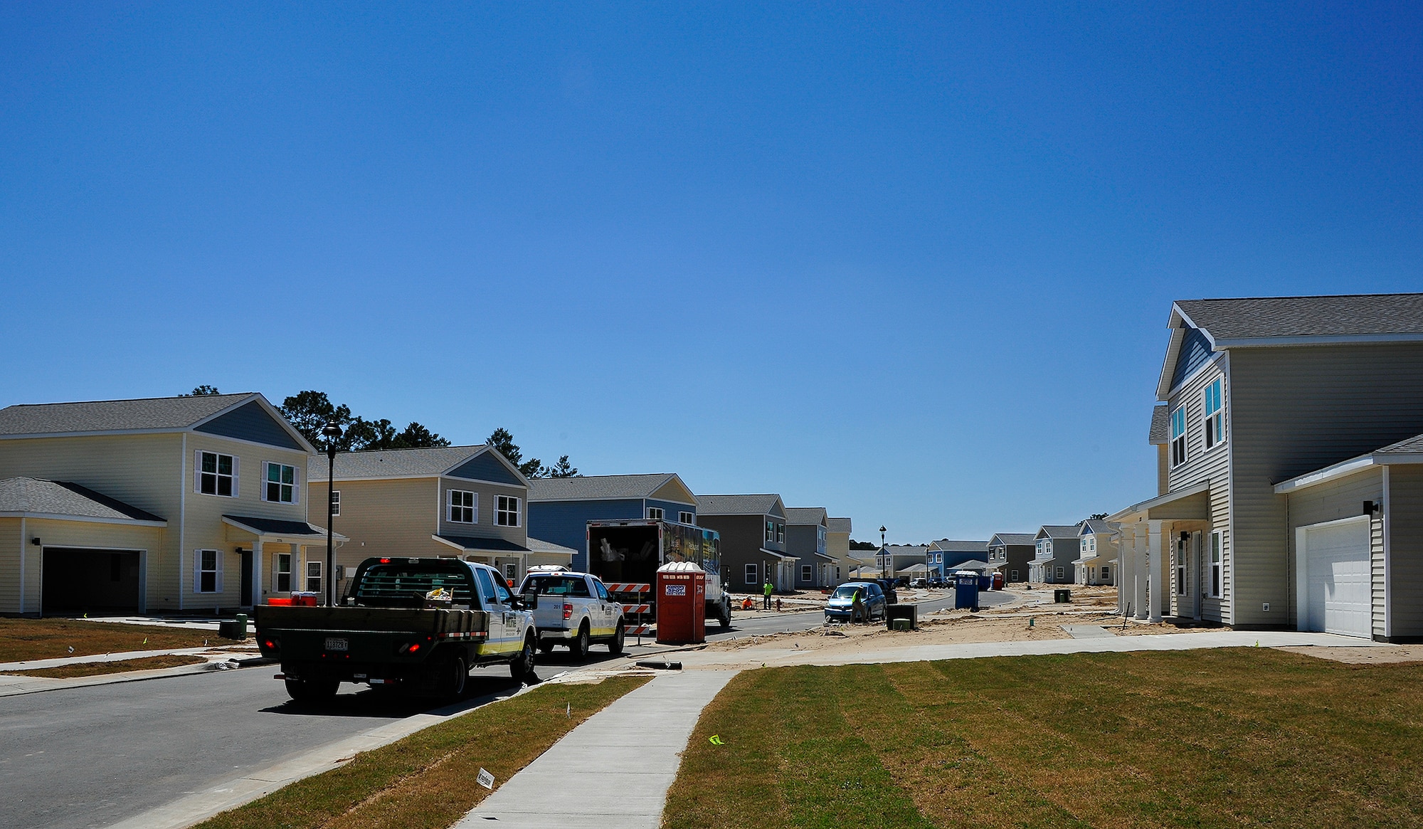 Construction workers complete several of the 747 privatized homes being built on Eglin Air Force Base, Fla., April 7. The new development will include multiple playgrounds, a dog-friendly “bark” park, a community center with a fitness room, and a pool. The entire community is estimated to be completed by 2019. (U.S. Air Force Photo/Jasmine Porterfield) 